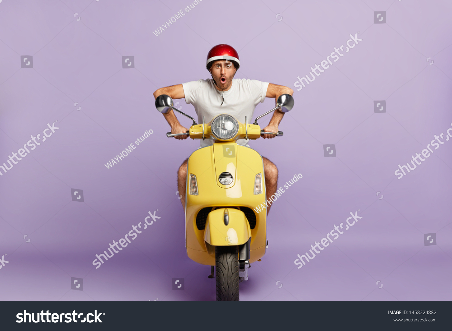 Terrified moped driver drives on high speed in helmet, stares at camera, wants to be in time, delivers something for customers, works as courier, isolated on purple background. Transportation concept #1458224882
