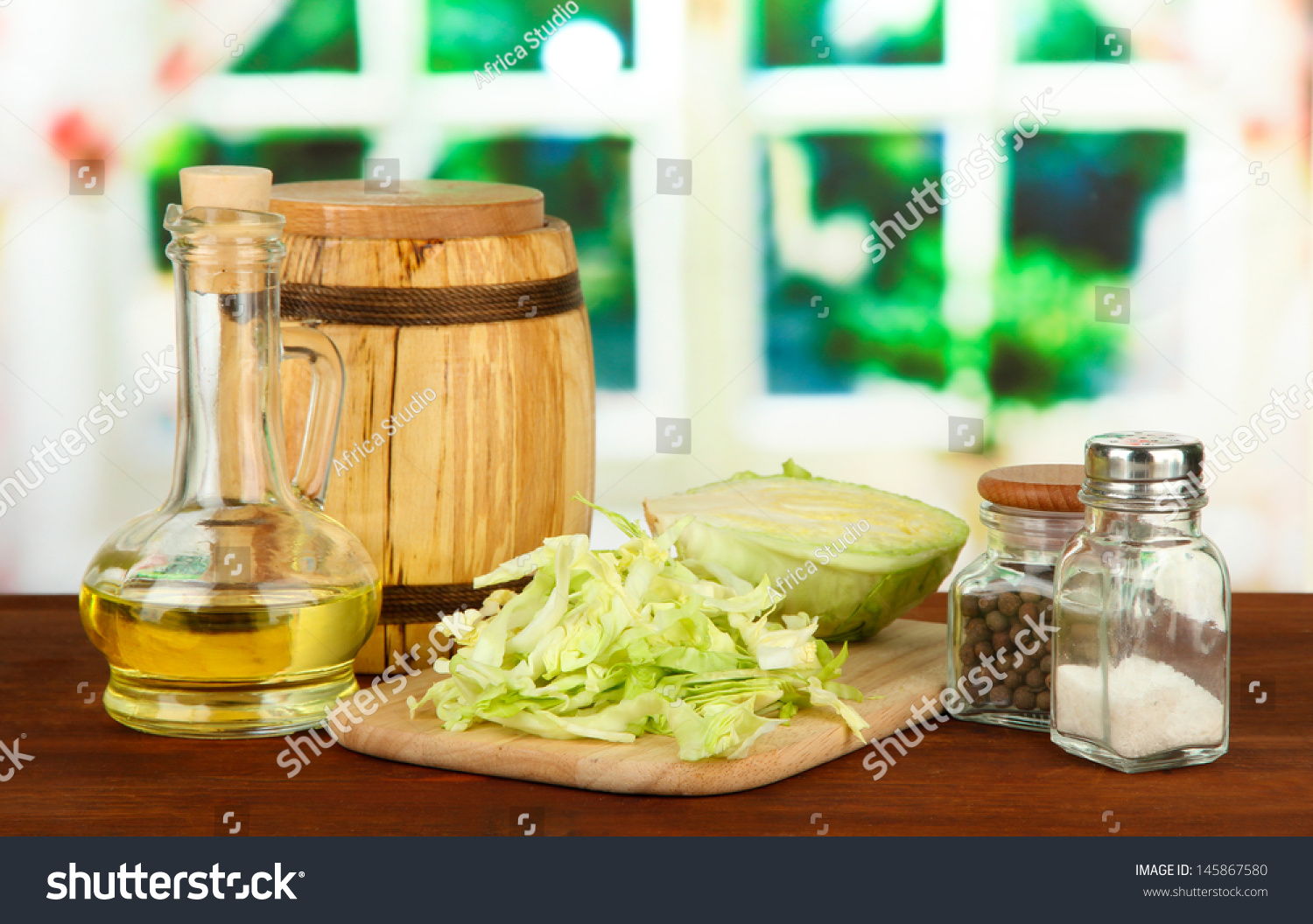 Green cabbage, oil, spices on cutting board, on bright background #145867580