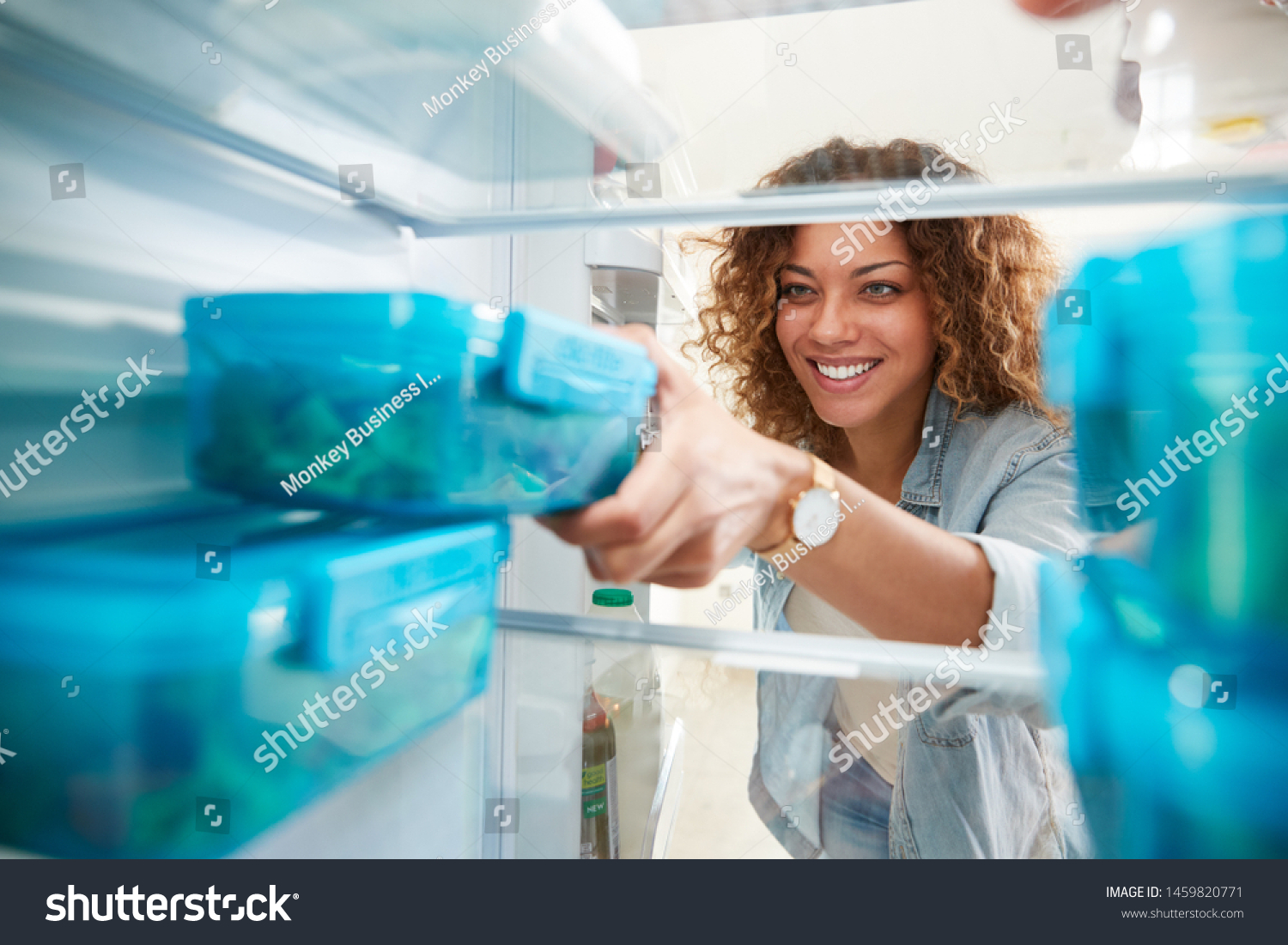 View Looking Out From Inside Of Refrigerator As Woman Takes Out Healthy Packed Lunch In Container #1459820771