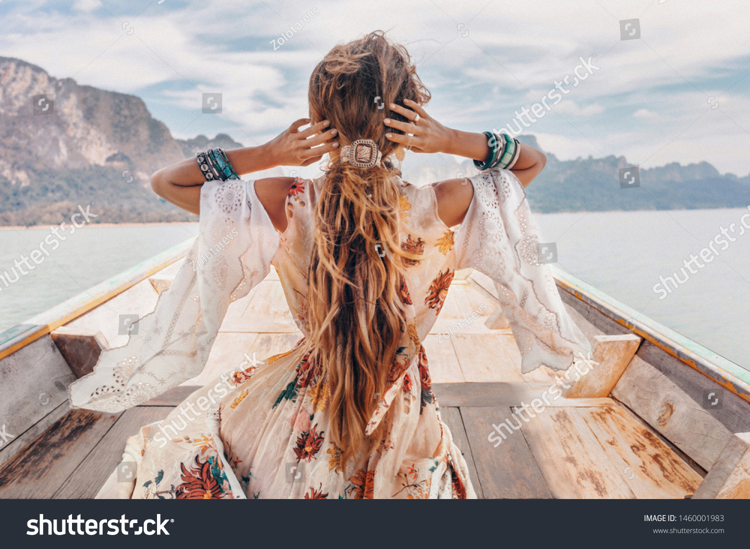 fashionable young model in boho style dress on boat at the lake  #1460001983