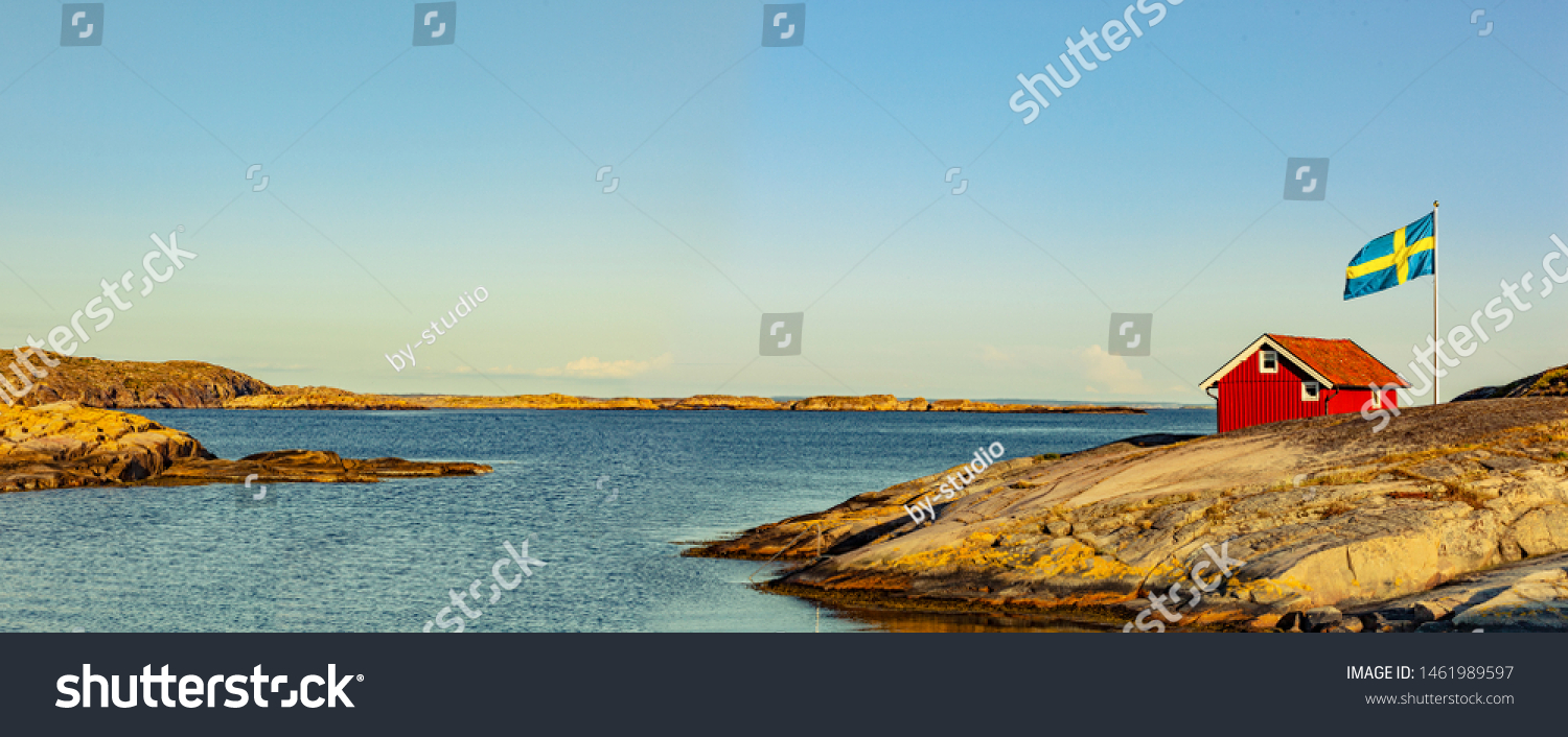 Red house in Sweden at the skerry coast with flag #1461989597