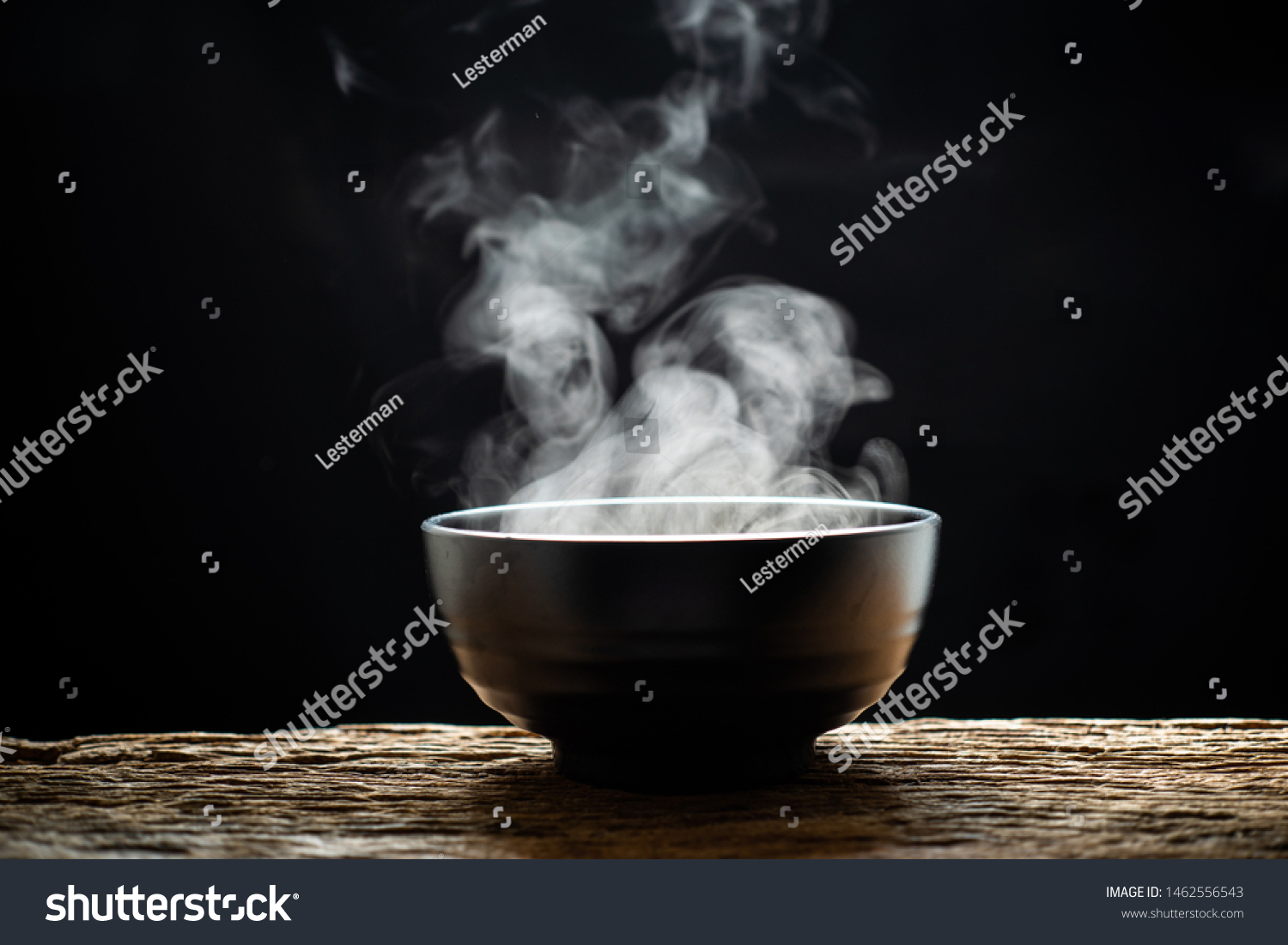 Steam of hot soup with smoke wood bowl on dark background.selective focus.hot food concept #1462556543