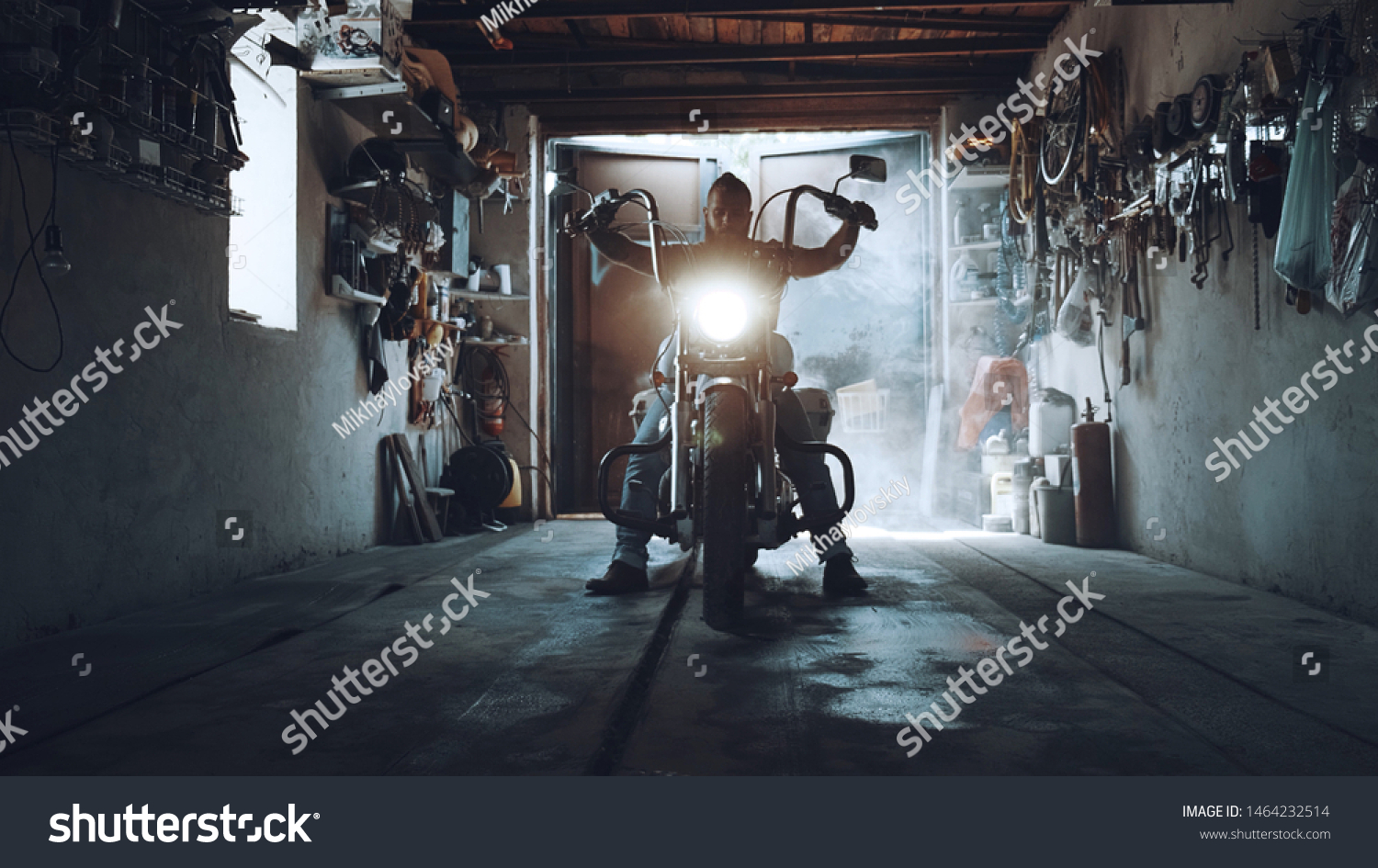 American biker with his motorcycle in the garage. cool and powerful chopper which the biker collected with his own hands #1464232514