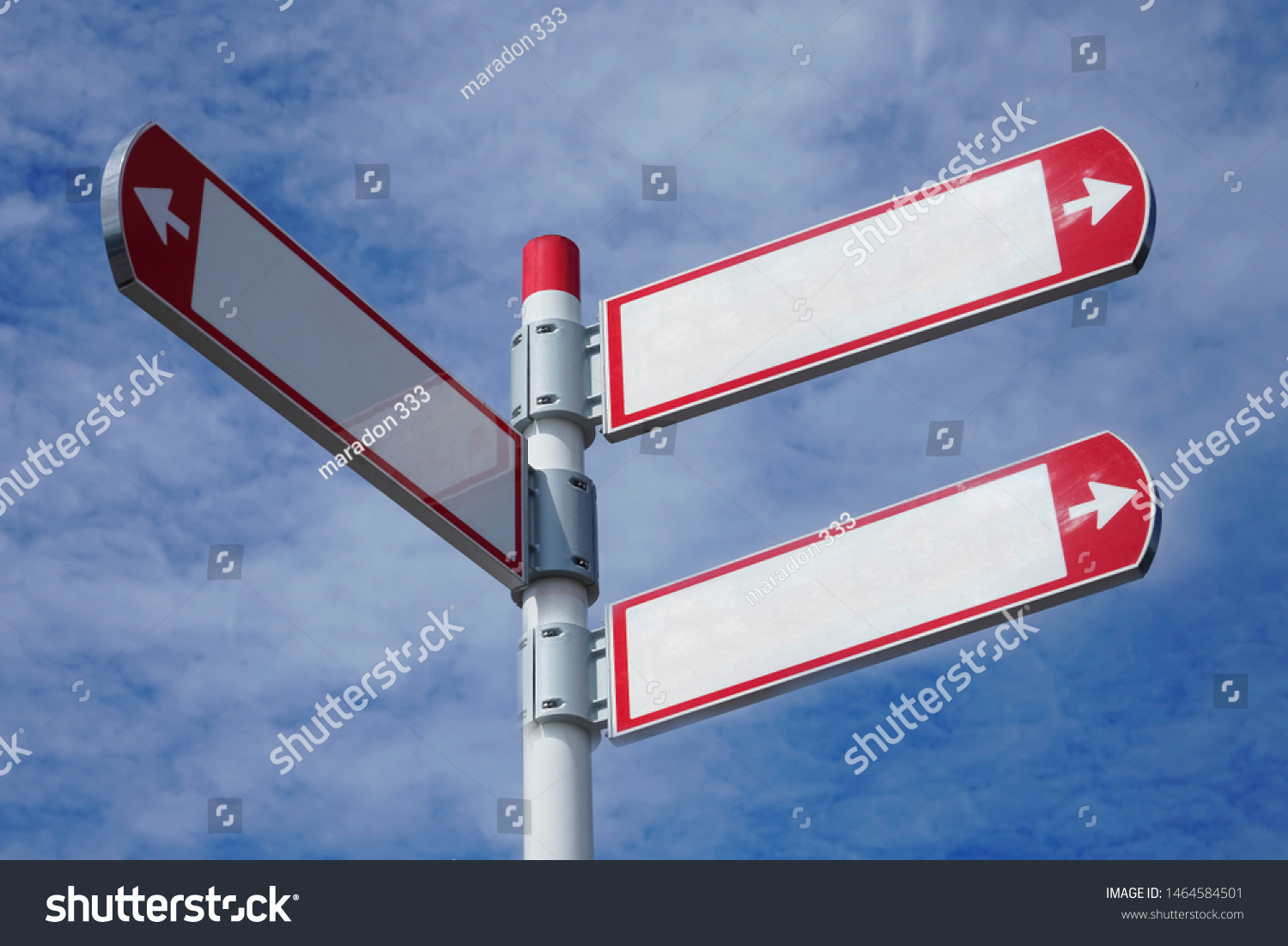 red direction sign on the pole against the blue cloudy sky. white arrow signal against heaven with clods.  empty frame blank  #1464584501