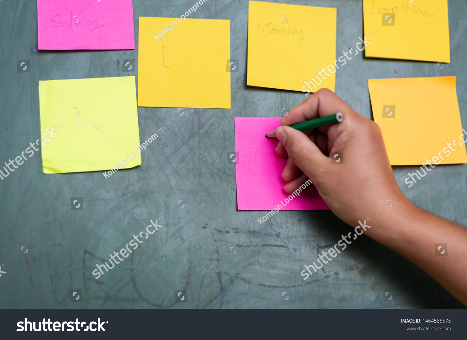 Close up woman hand writing colorful note sticky for brainstorm and share idea strategy workshop business.Brainstorming concept. #1464585575