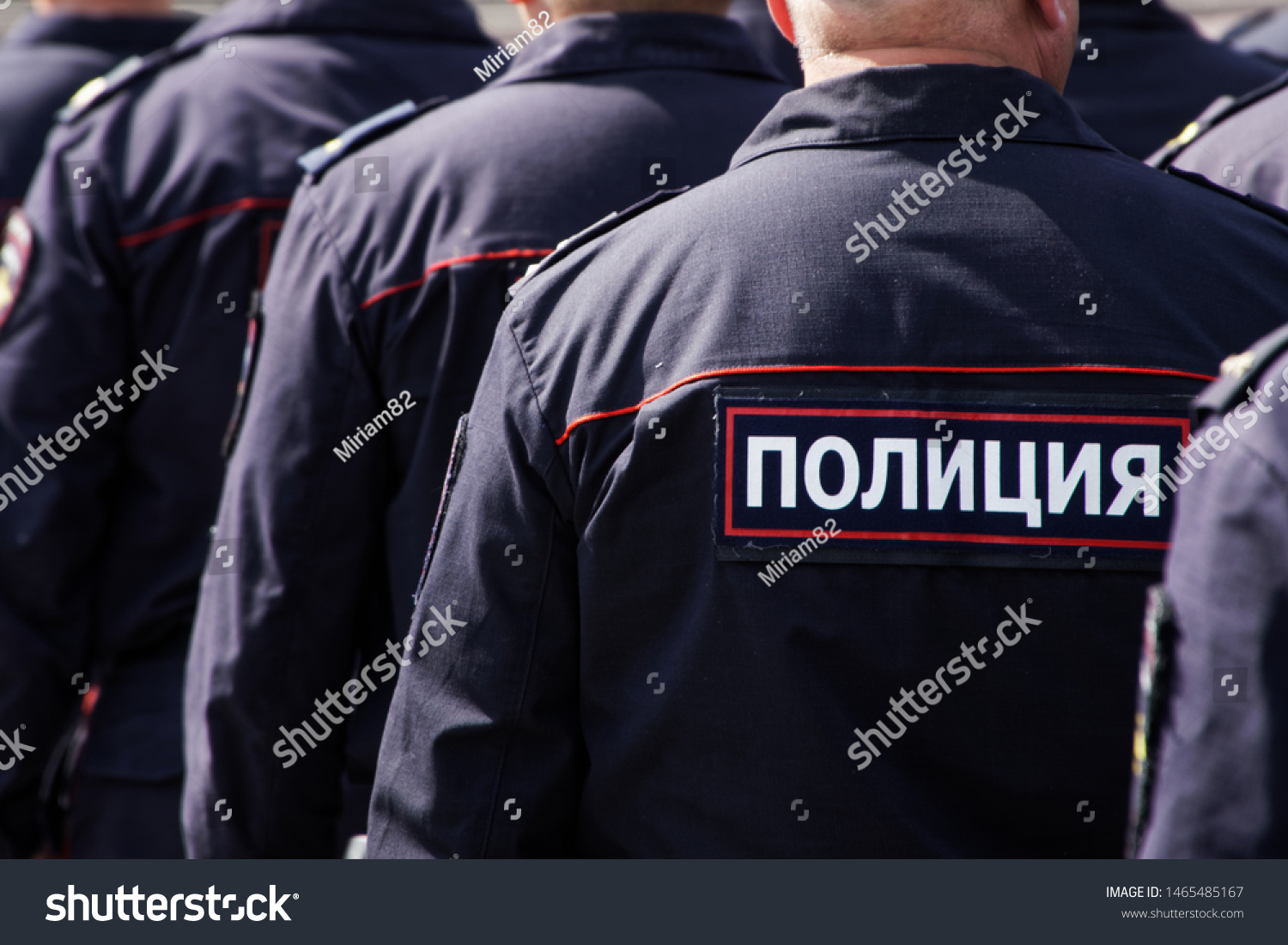 Russian police officers work on a city street. View from the back. Problems of opposition rallies, detentions and arrests. The inscription on the uniform: the police #1465485167