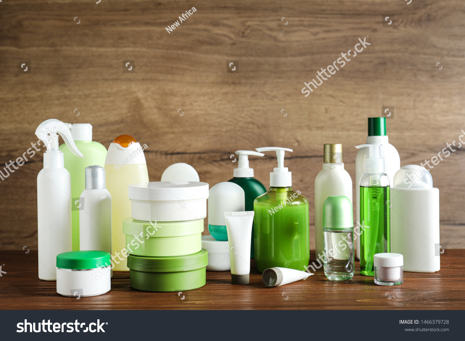 Different body care products on table against wooden background #1466379728