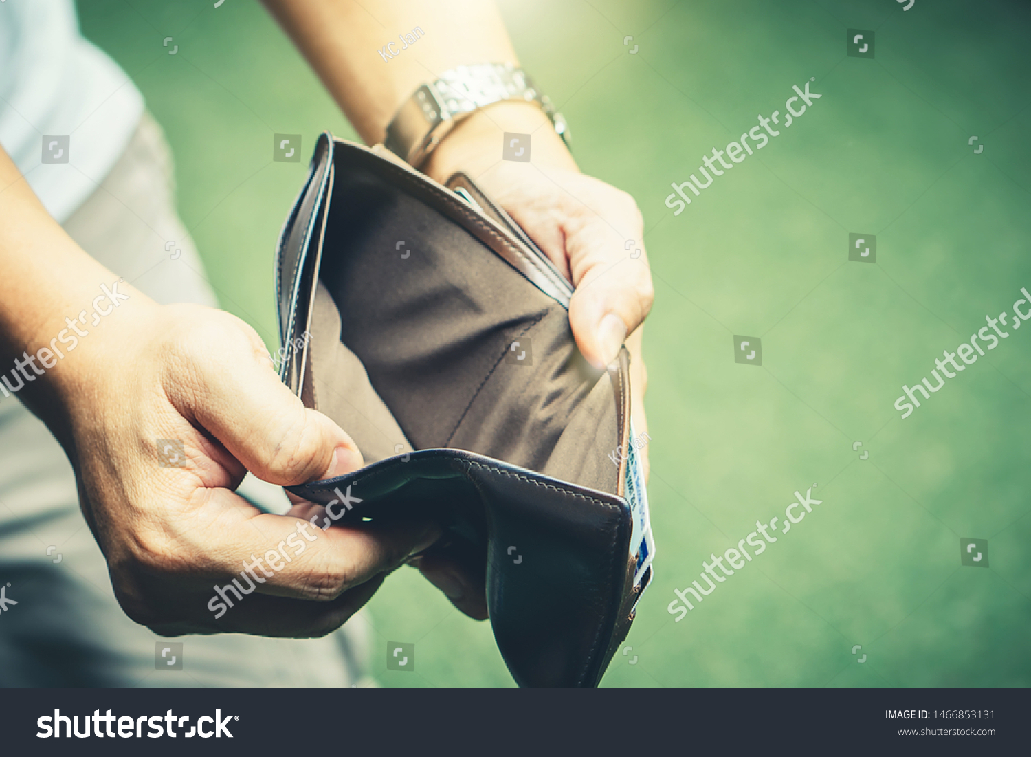 Poor man bankrupt with no credit in debt hand hold empty black leather wallet because economy down turn depression crisis fail working saving finance money plan loss job unemploy. No money to pay #1466853131