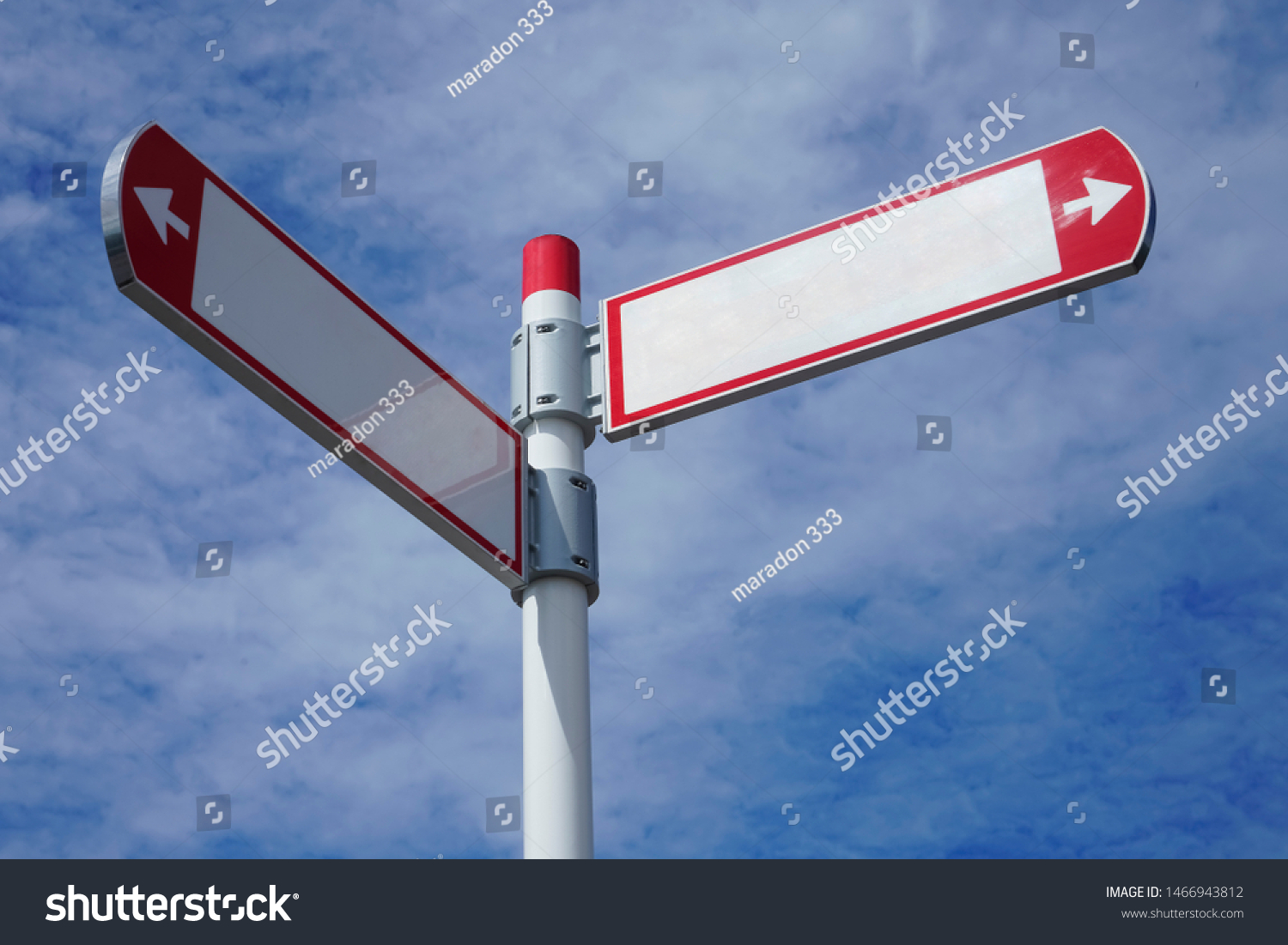 red direction sign on the pole against the blue cloudy sky. white arrow signal against heaven with clods.  empty frame blank  #1466943812