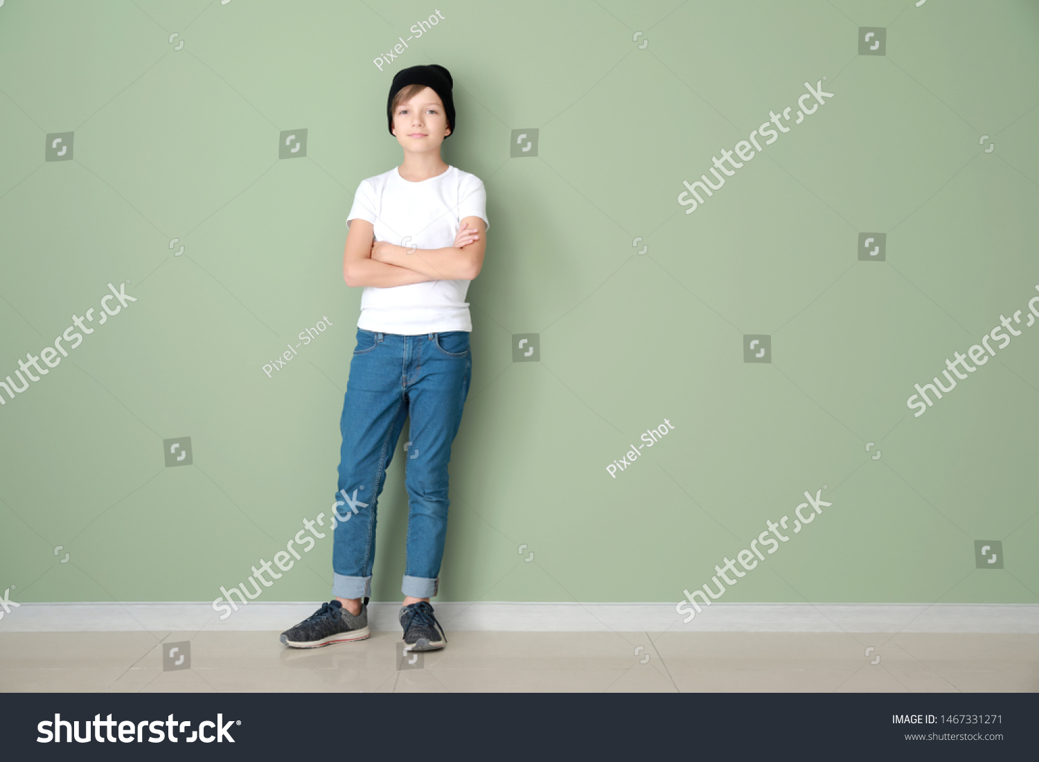 Stylish boy in jeans near color wall #1467331271