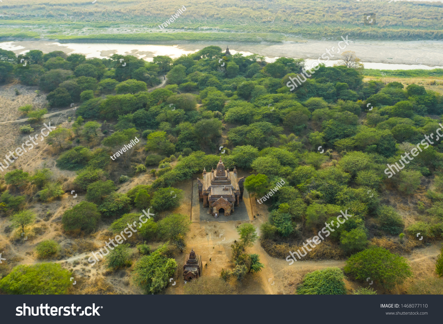 View from above, stunning aerial view of the beautiful Bagan Archaeological Zone (formerly Pagan) during sunset. Drone picture over hundreds of temples surrounded green rich vegetation, Myanmar. #1468077110