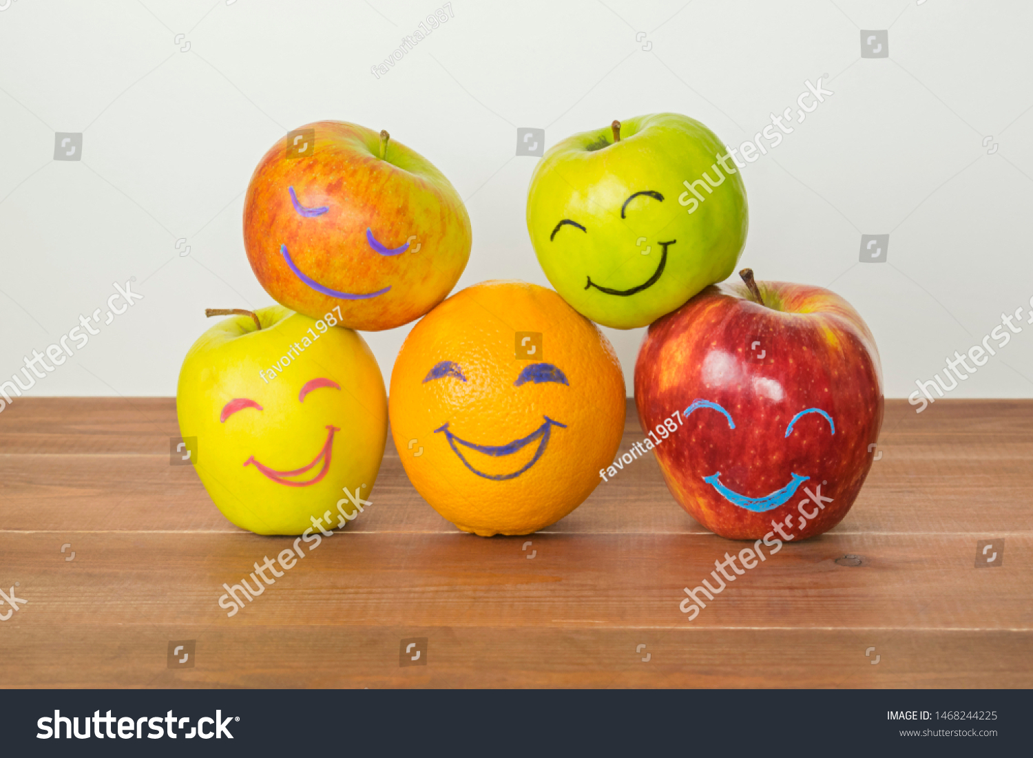 Different apples and orange with funny faces, tolerance, originality or friendship concept.  #1468244225