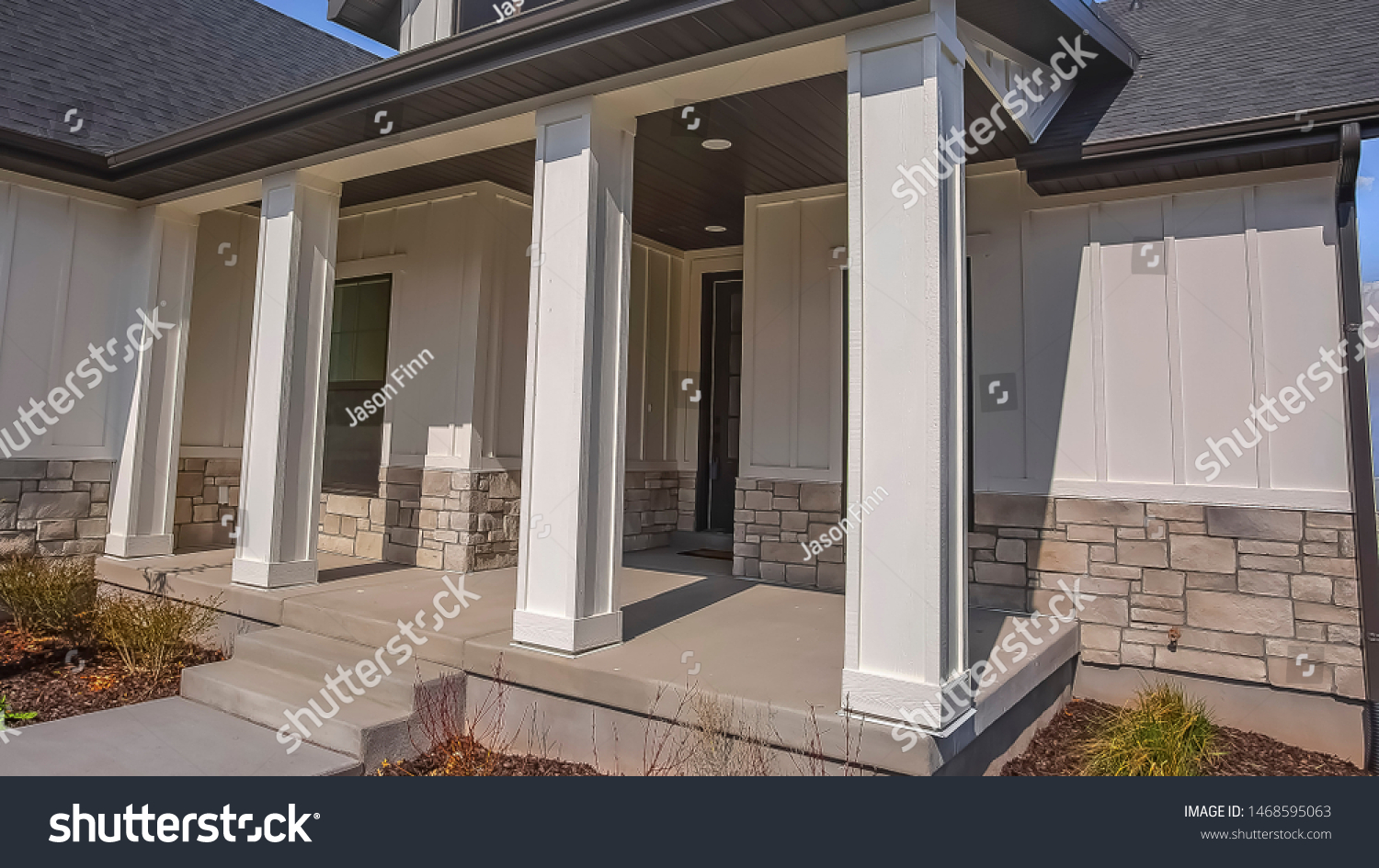 Panorama Pathway and stairs leading to the porch with pillars at the facade of a home #1468595063