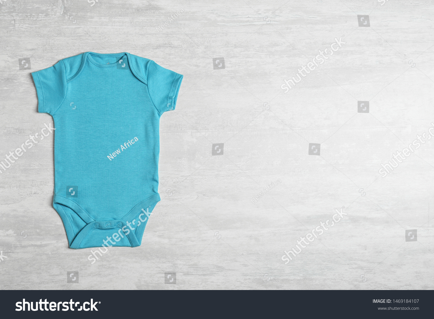 Baby bodysuit on wooden background, top view. Space for text #1469184107