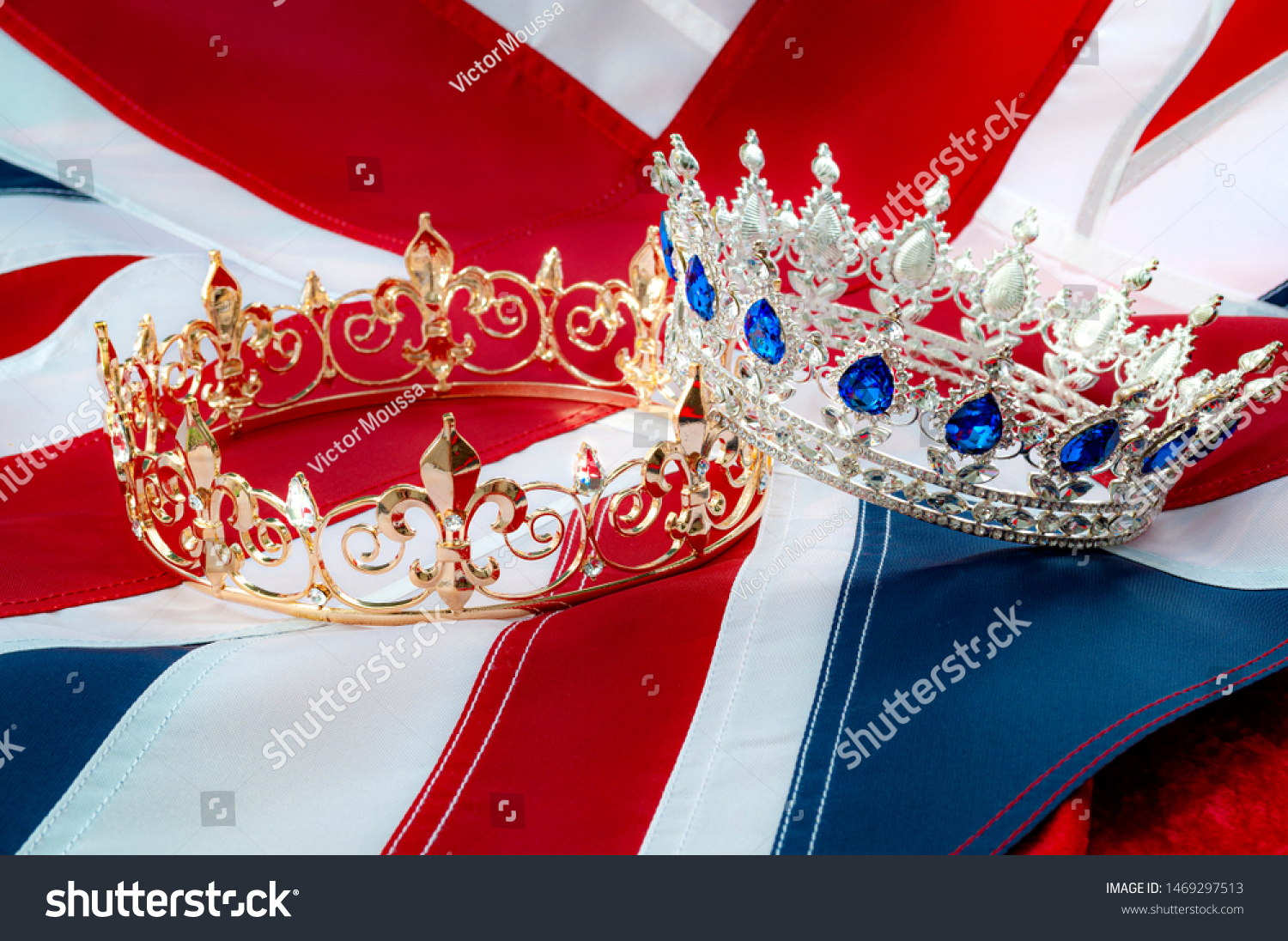 British royals, royal coronation and monarchy concept theme with a gold king crown and a silver queen tiara with the UK flag called the union jack in the background #1469297513