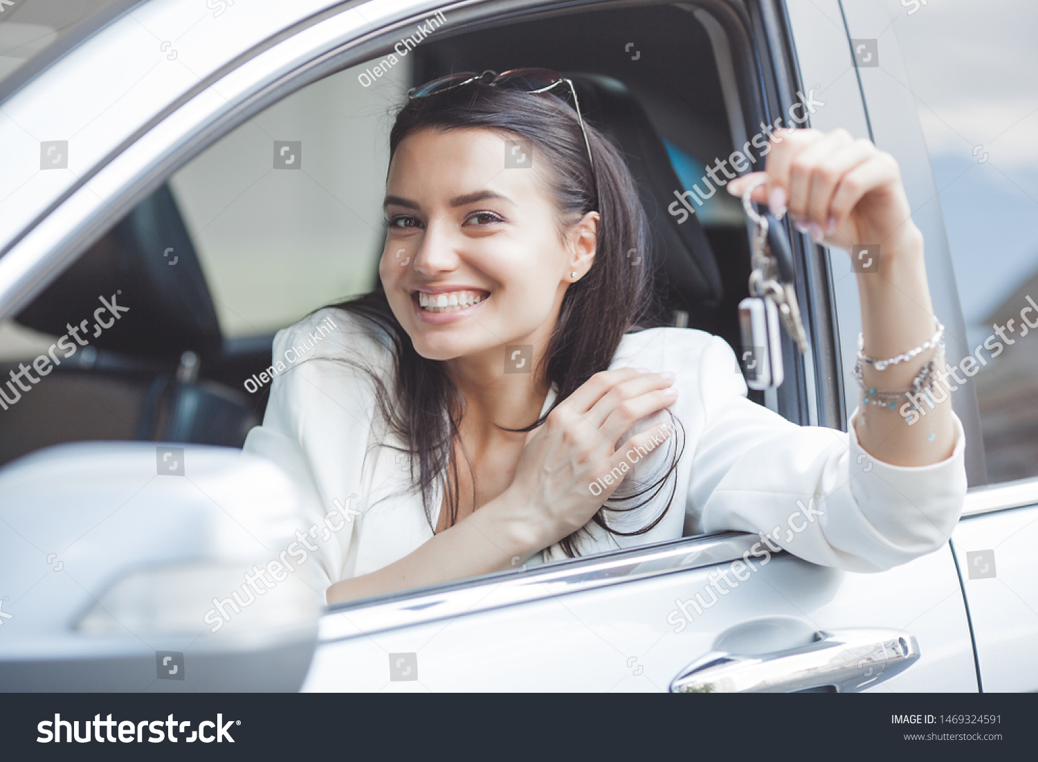 Young attractive woman just bought a new car. female holding keys from new automobile. #1469324591