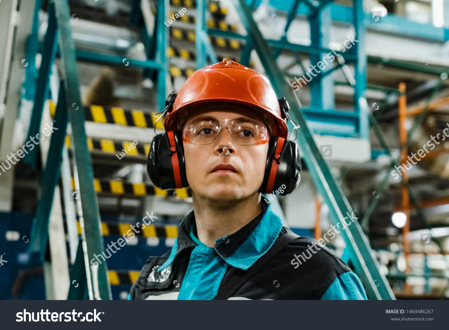 Tobolsk, Russia - June 19, 2019: A worker of an oil refinery in overalls and a helmet inspects equipment. #1469486267