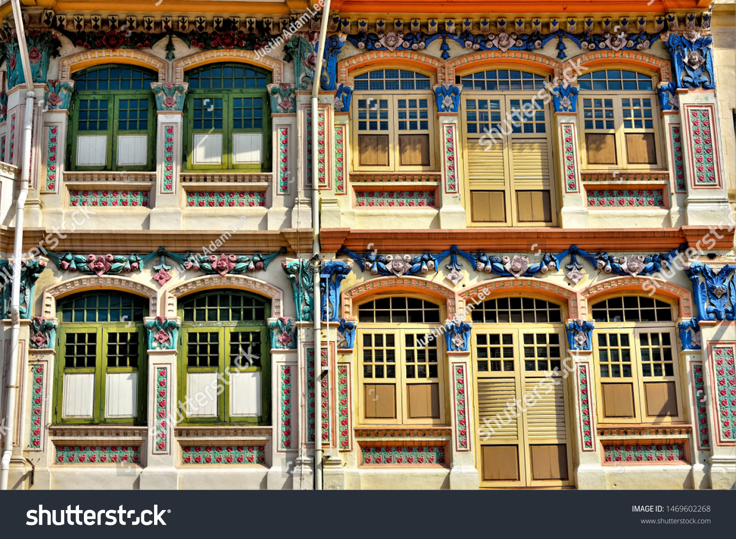 Front view of traditional Straits Chinese or Peranakan Singapore shop house exteriors with arched windows, antique wooden shutters and colourful exterior in Jalan Besar, Singapore
 #1469602268