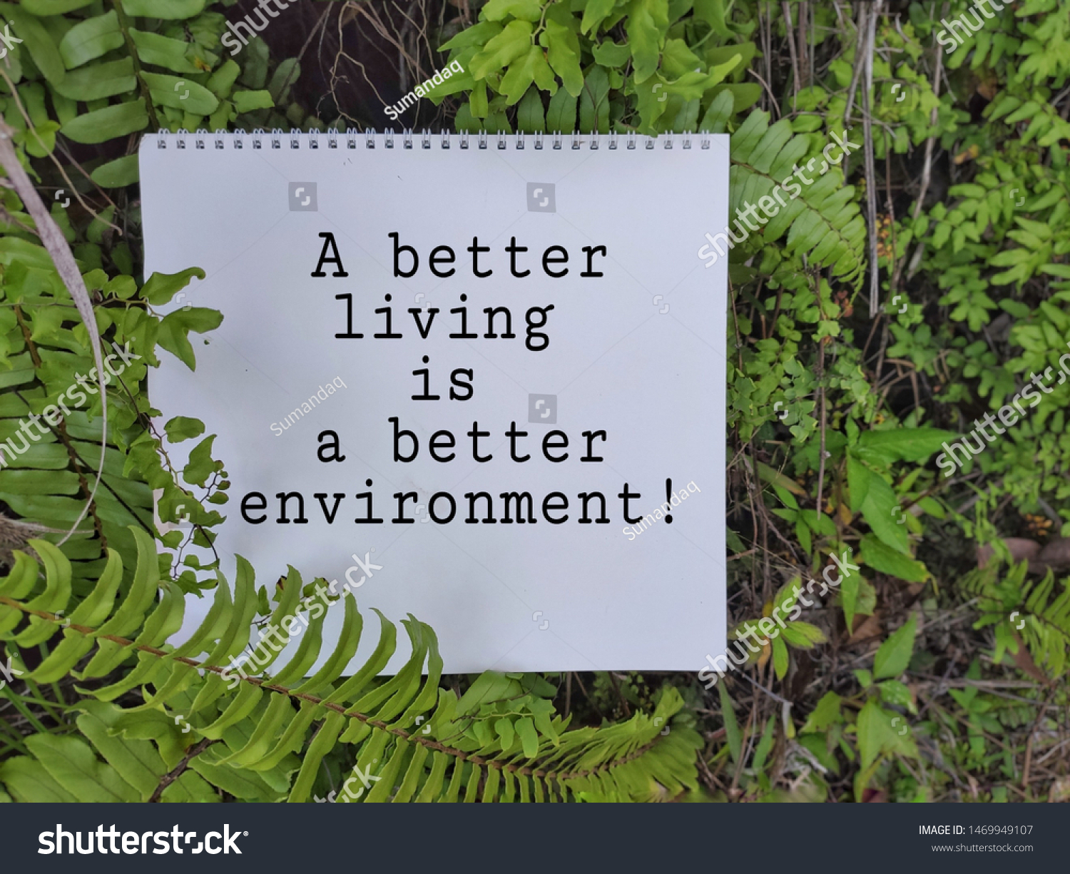 motivational and inspirational words of a better living is a better environment on notepad with green leaves background #1469949107