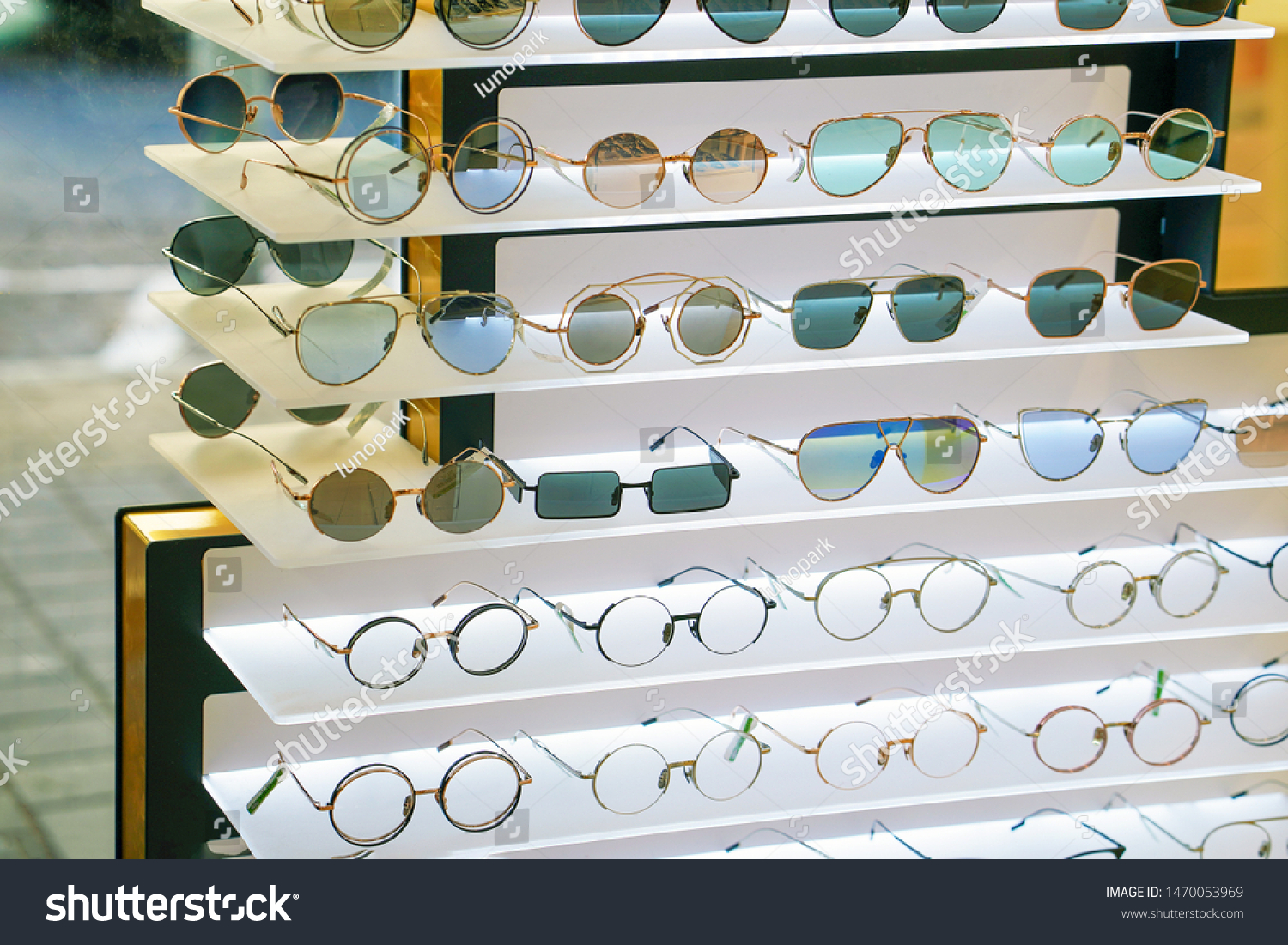 Stand with sunglasses. Sale the city market or in the store sunglasses. Trendy sunglasses, Summer eyeglasses, fashion collection, Different sunglasses on a stand.                                #1470053969