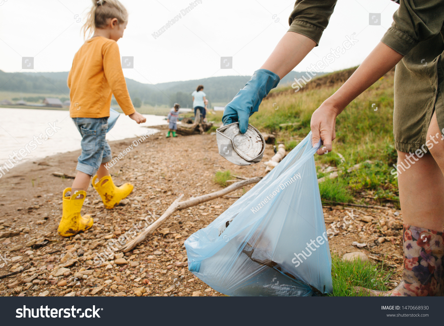 Close-up of a garbage collector by the river.  Family eco tourism. Environmental pollution. Ecological problem. #1470668930