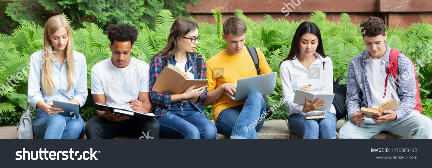 Preparing for lecture. Teens sitting in university campus with books and devices #1470803492
