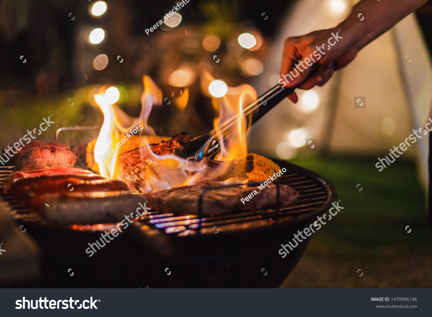 Family making barbecue in dinner party camping at night #1470996146