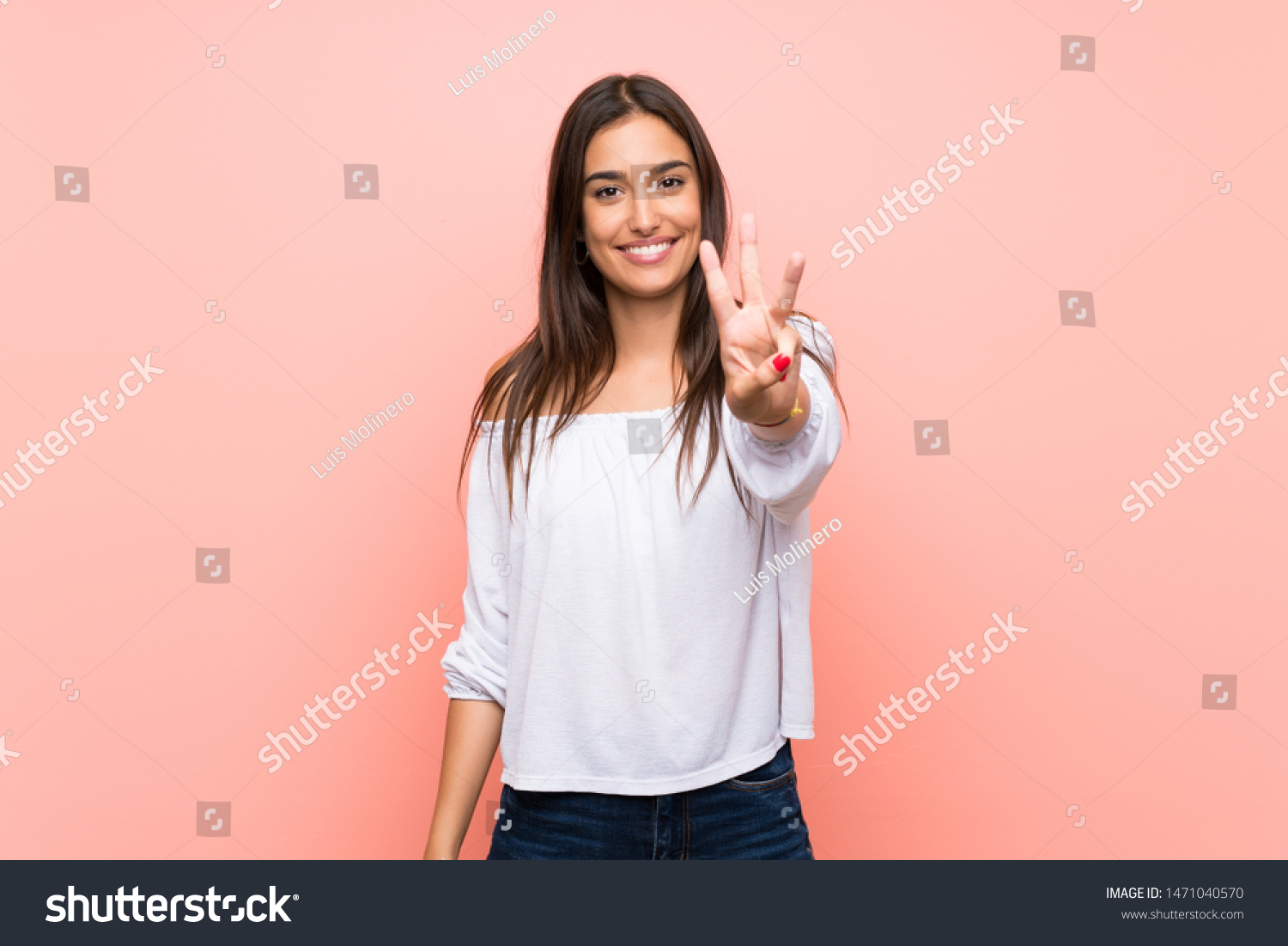 Young woman over isolated pink background happy and counting three with fingers #1471040570