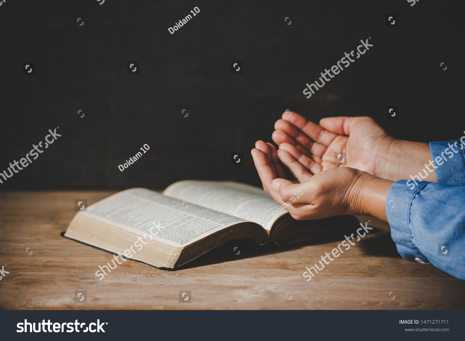Spirituality and religion, Hands folded in prayer on a Holy Bible in church concept for faith. #1471271711