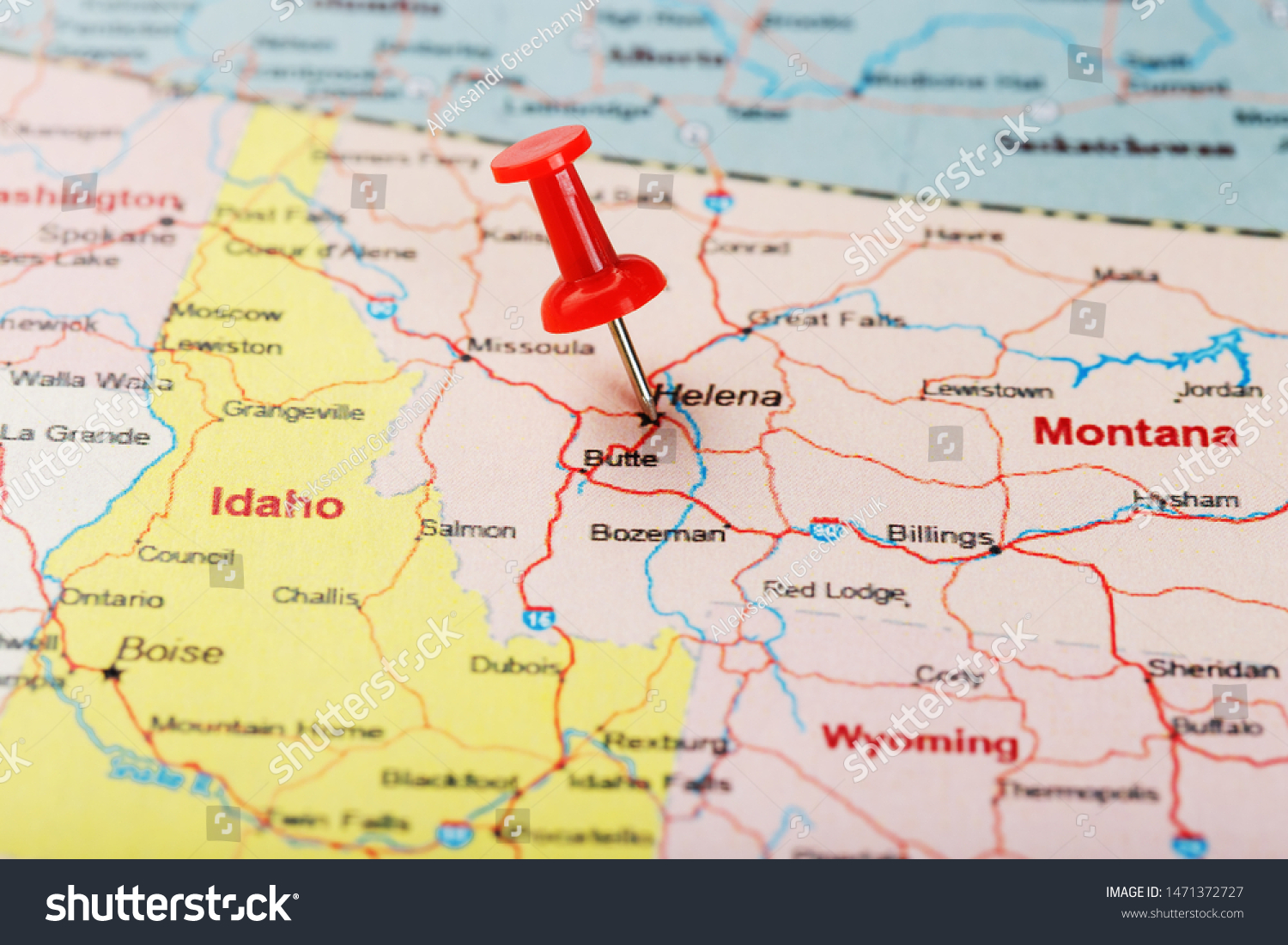 Red clerical needle on a map of USA, Montana and the capital of Helena. Close up Montana map with red tack US map pin #1471372727