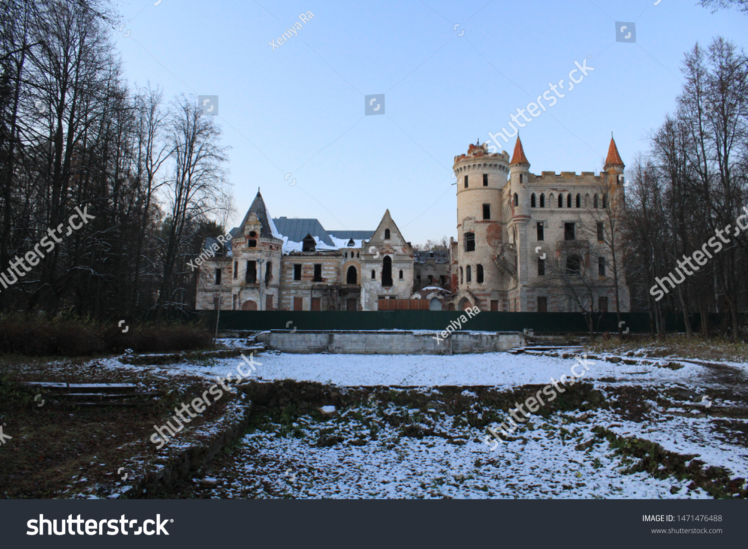 Winter landscape with crumbling castle on the background of grass covered with snow #1471476488