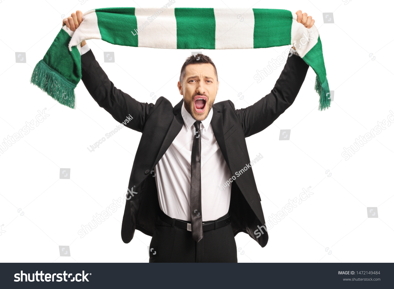Cheerful young man in a suit cheering with a scarf isolated on white background #1472149484
