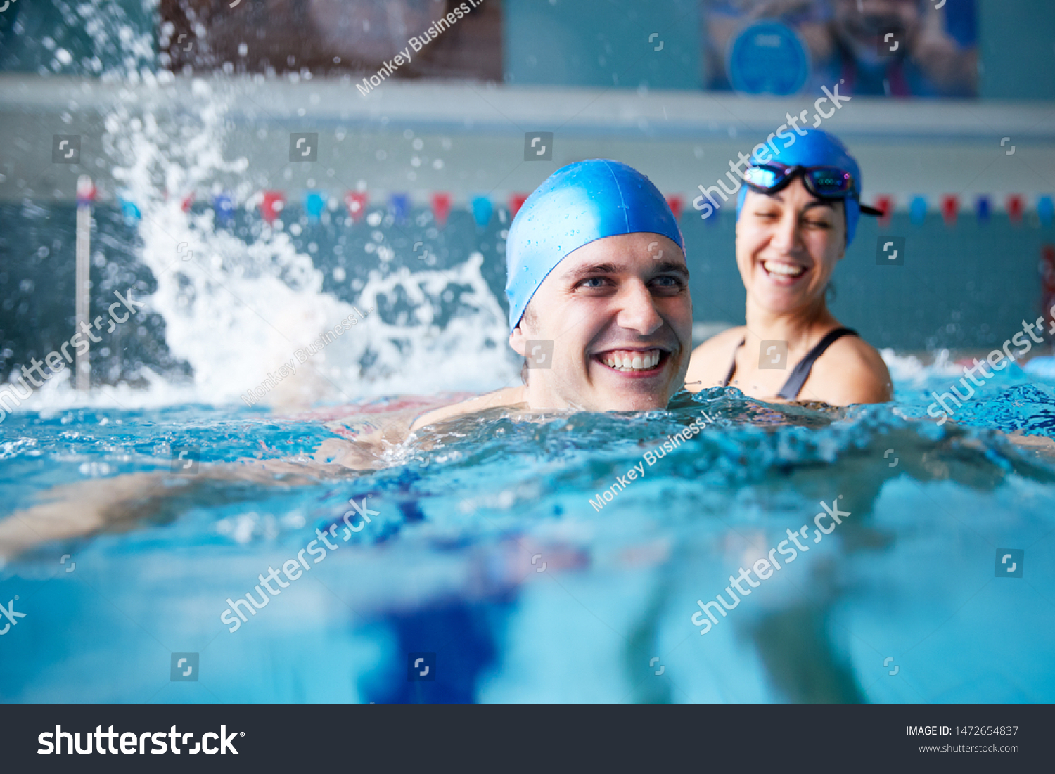 Female Swimming Teacher Giving Man One To One Lesson In Pool #1472654837