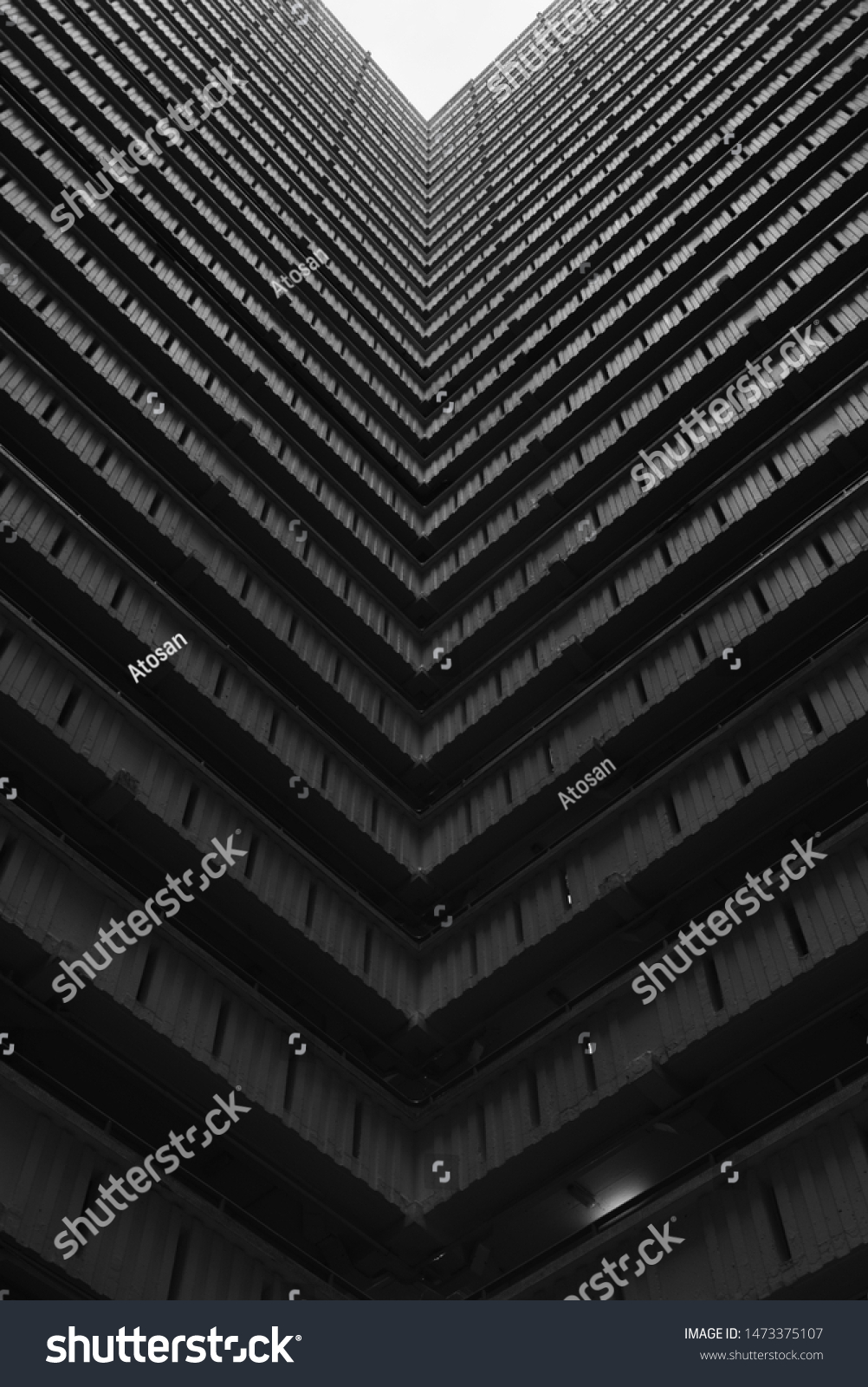 Hong Kong, China - 24 June 2019: Bottoms up view of the cascading corridors opening up to the sky at an old public housing estate in Ping Shek, Kwun Tong District, Kowloon, Hong Kong.  #1473375107