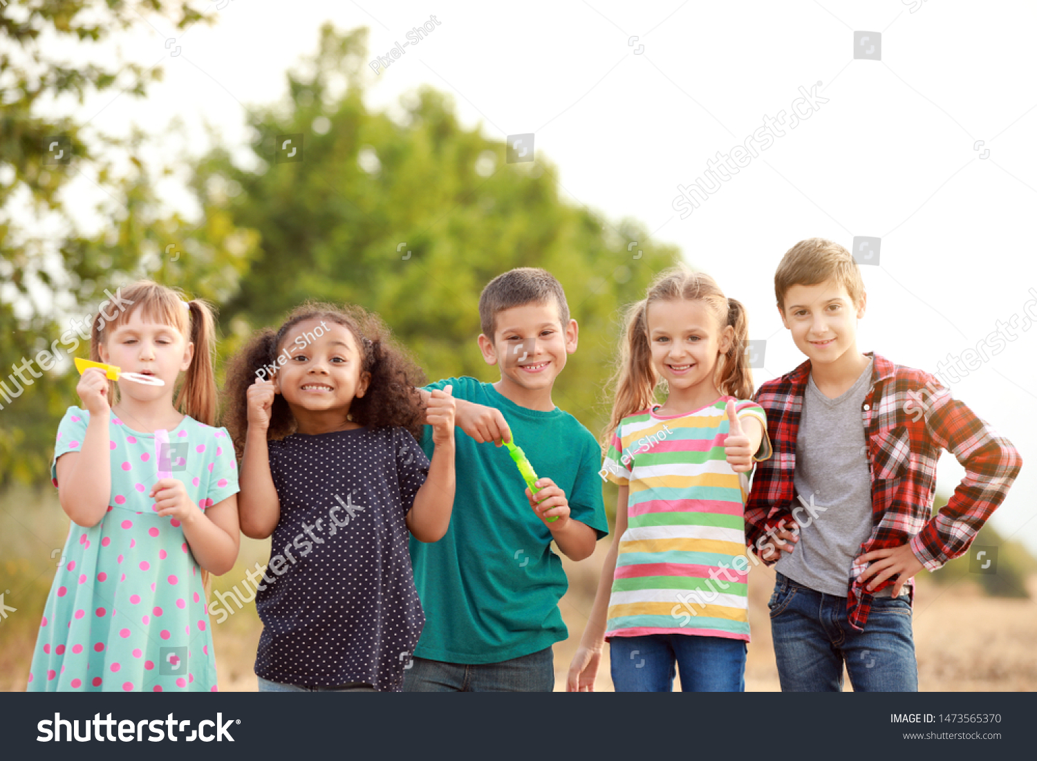Portrait of cute little children showing thumb-up gesture outdoors #1473565370