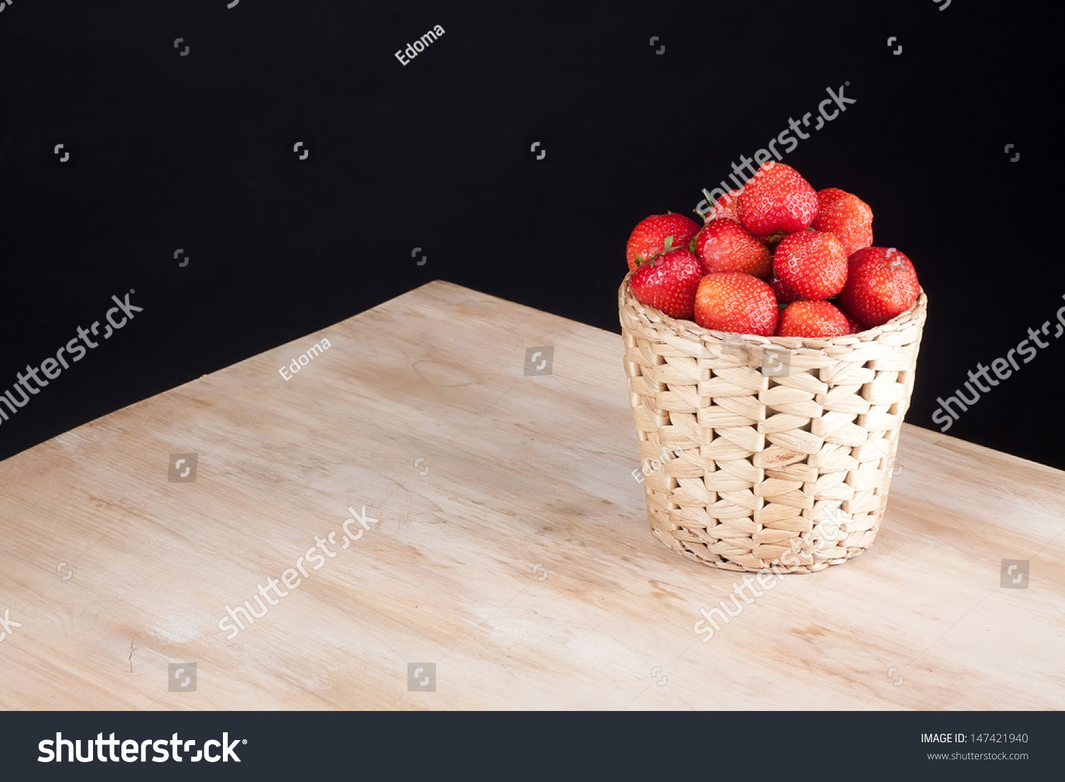 Strawberries in basket on wooden table #147421940