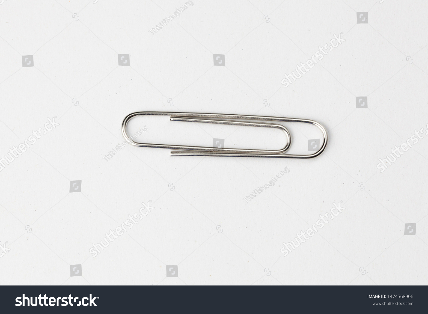 Metal paper clip isolated on white background #1474568906