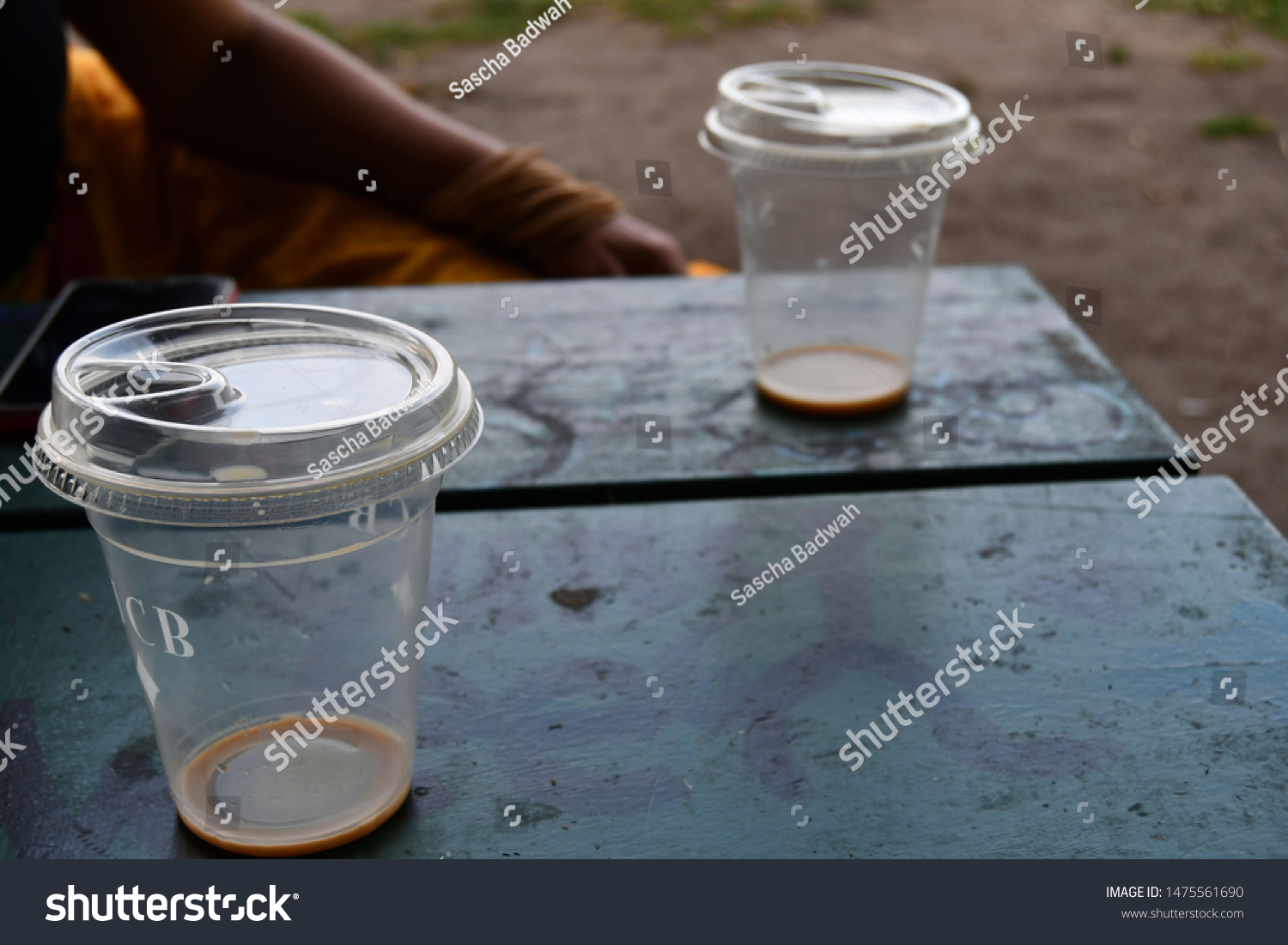 Toronto, Ontario: August 7, 2019: Two plastic cups on a park bench at Trinity Bellwoods Park between friends. #1475561690