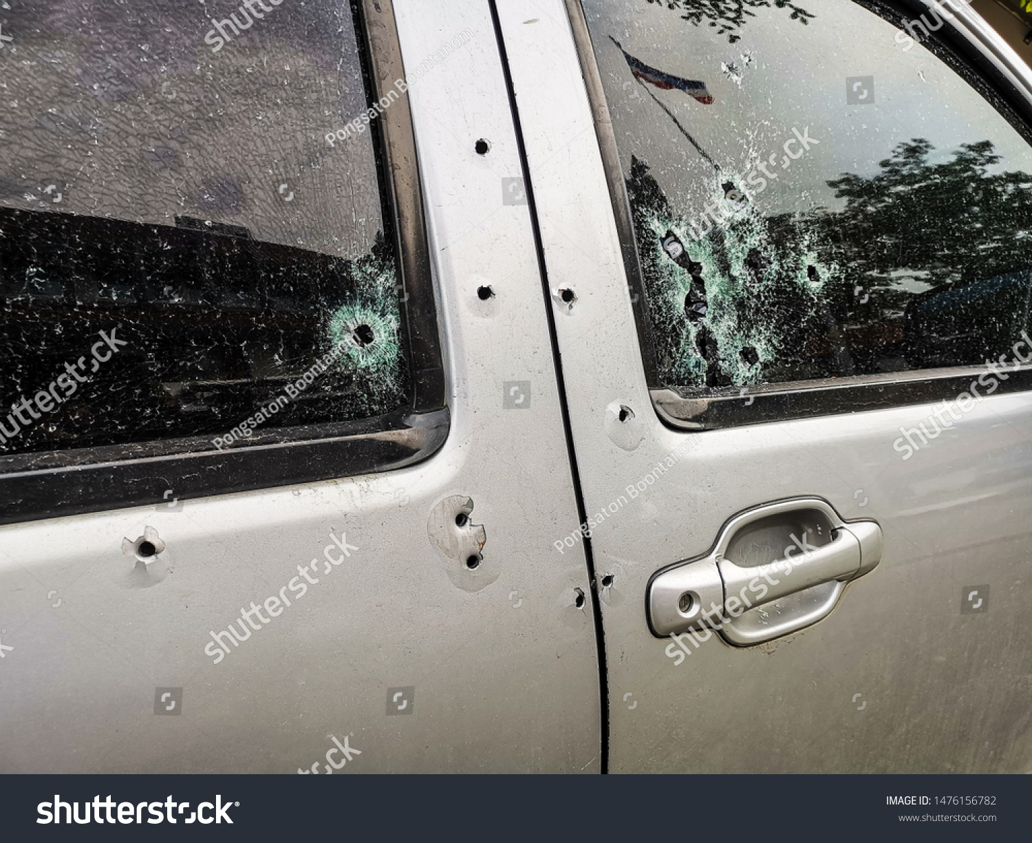 Car riddled with bullet holes . #1476156782