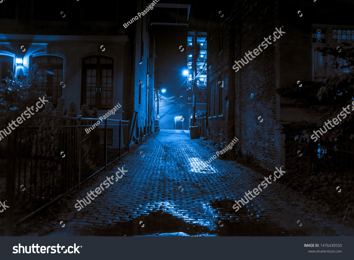Dark and scary vintage cobblestone brick city alley at night in Chicago #1476430550