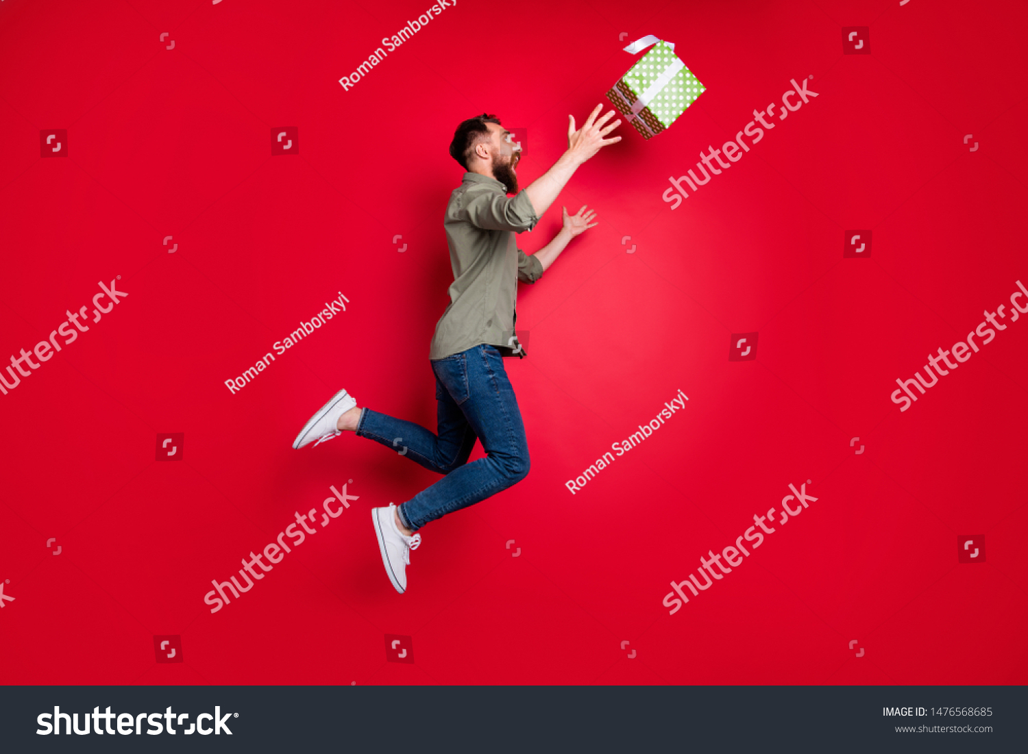 Full length body size photo of man trying to catch his prize gift while isolated with red background #1476568685
