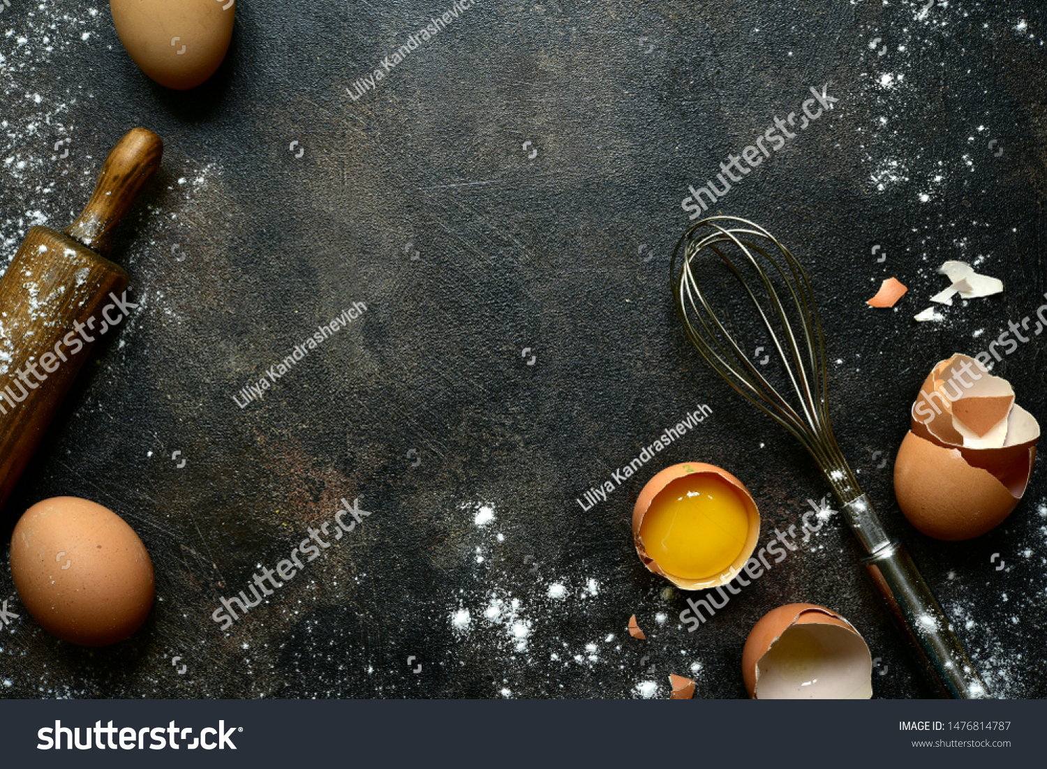 Culinary background with ingredients for baking : milk, butter,sugar, dough and egg on a dark slate, stone or concrete table. Top view with copy space. #1476814787