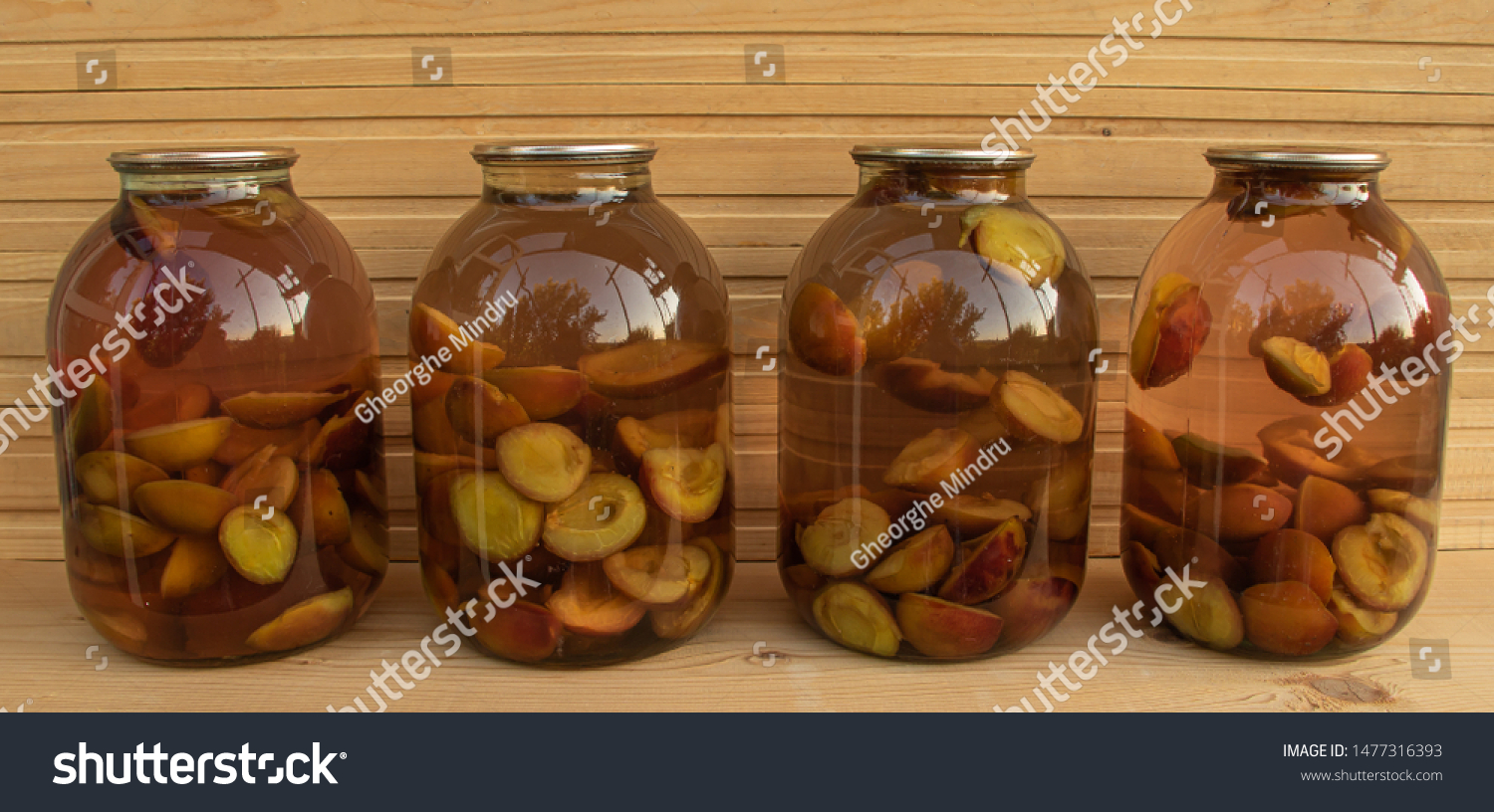 Fresh plum compote on wooden background freshly cooked #1477316393
