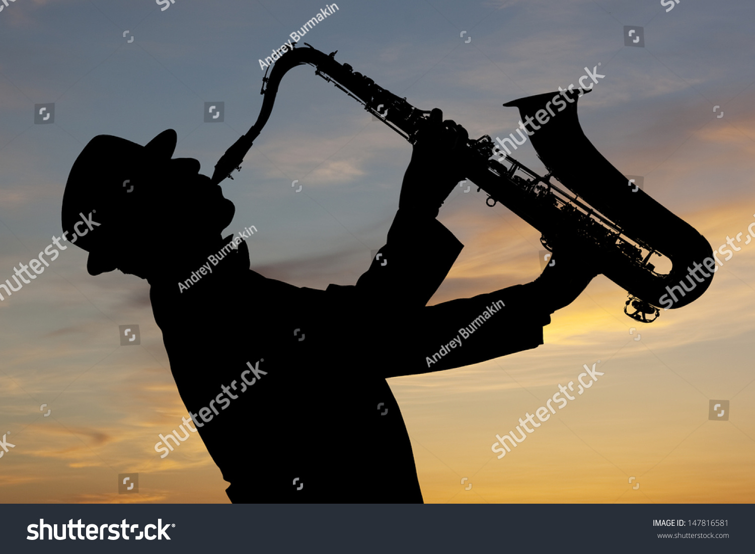 Saxophonist. Man playing on saxophone against the background of sunset #147816581