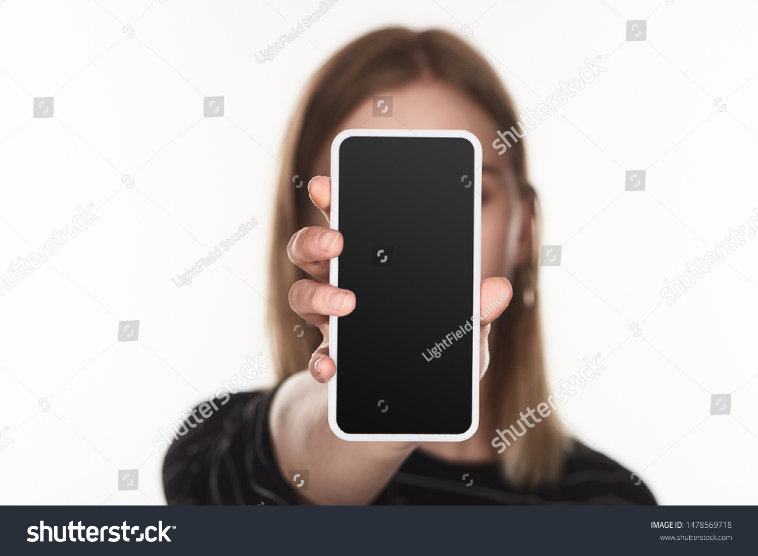 selective focus of victim of cyberbullying showing smartphone with blank screen isolated on white #1478569718