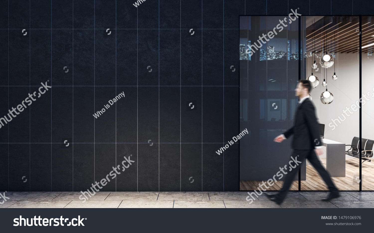 Businessman walking past dark wall business center with modern light conference room with wooden floor and black chairs. #1479106976