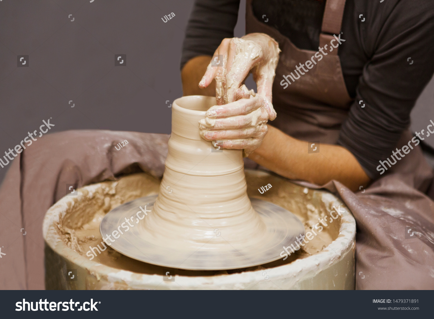 woman hands making ceramic pot on pottery wheel in workshop. hobby on pension
 #1479371891