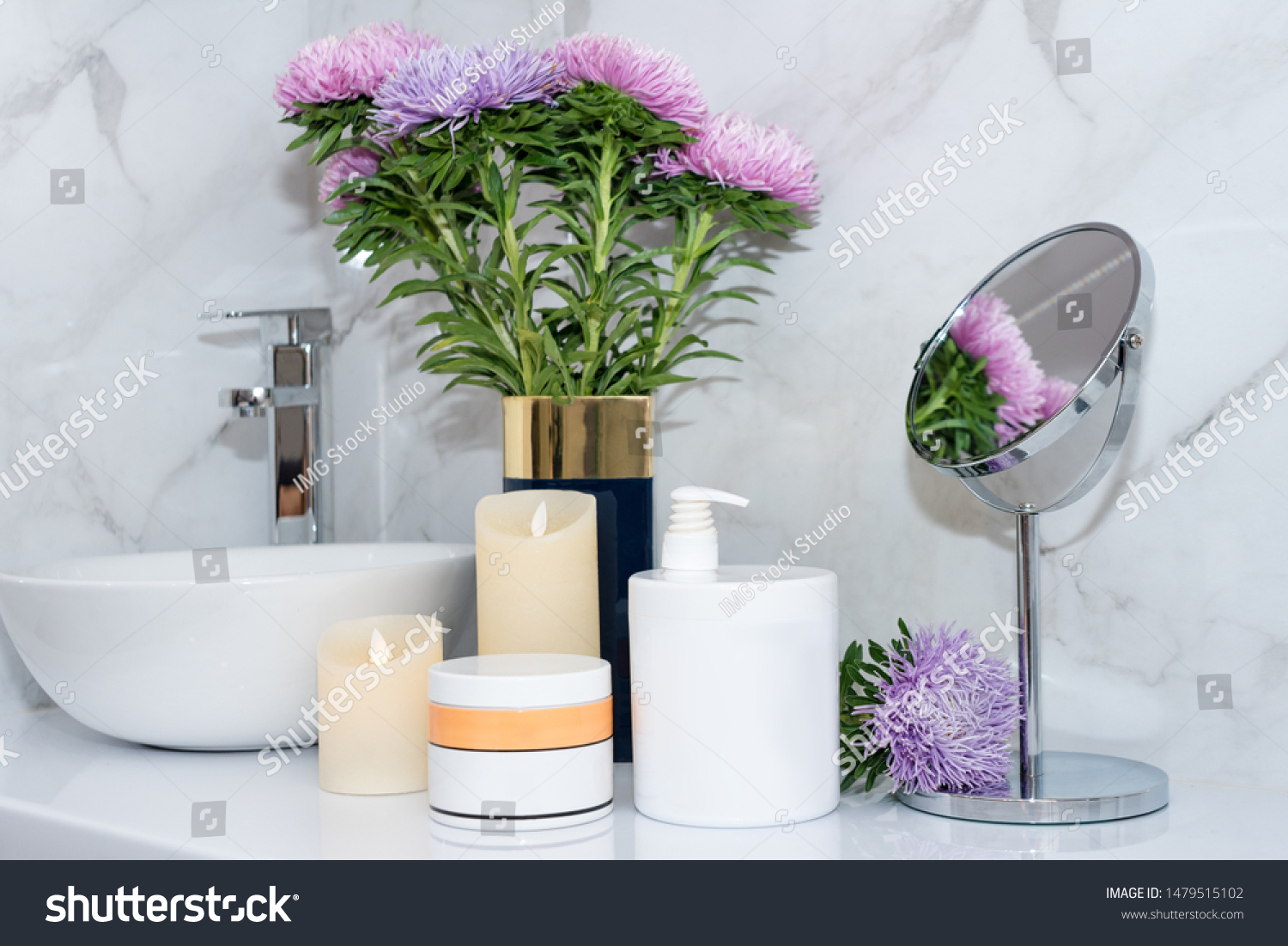 Set of natural cosmetics in beauty salon. Jars of body or hair care product on table with flowers. Space for text #1479515102