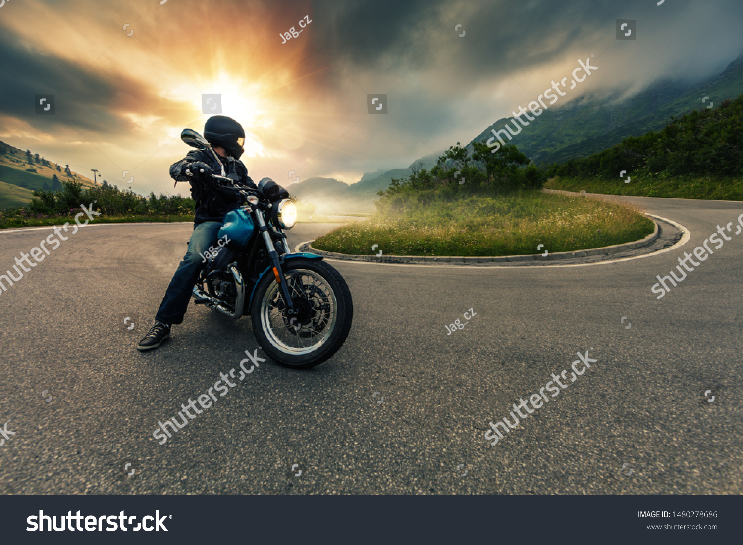 Motorcycle driver posing in Alpine landscape. Lifestyle photo with motion blur effect. #1480278686