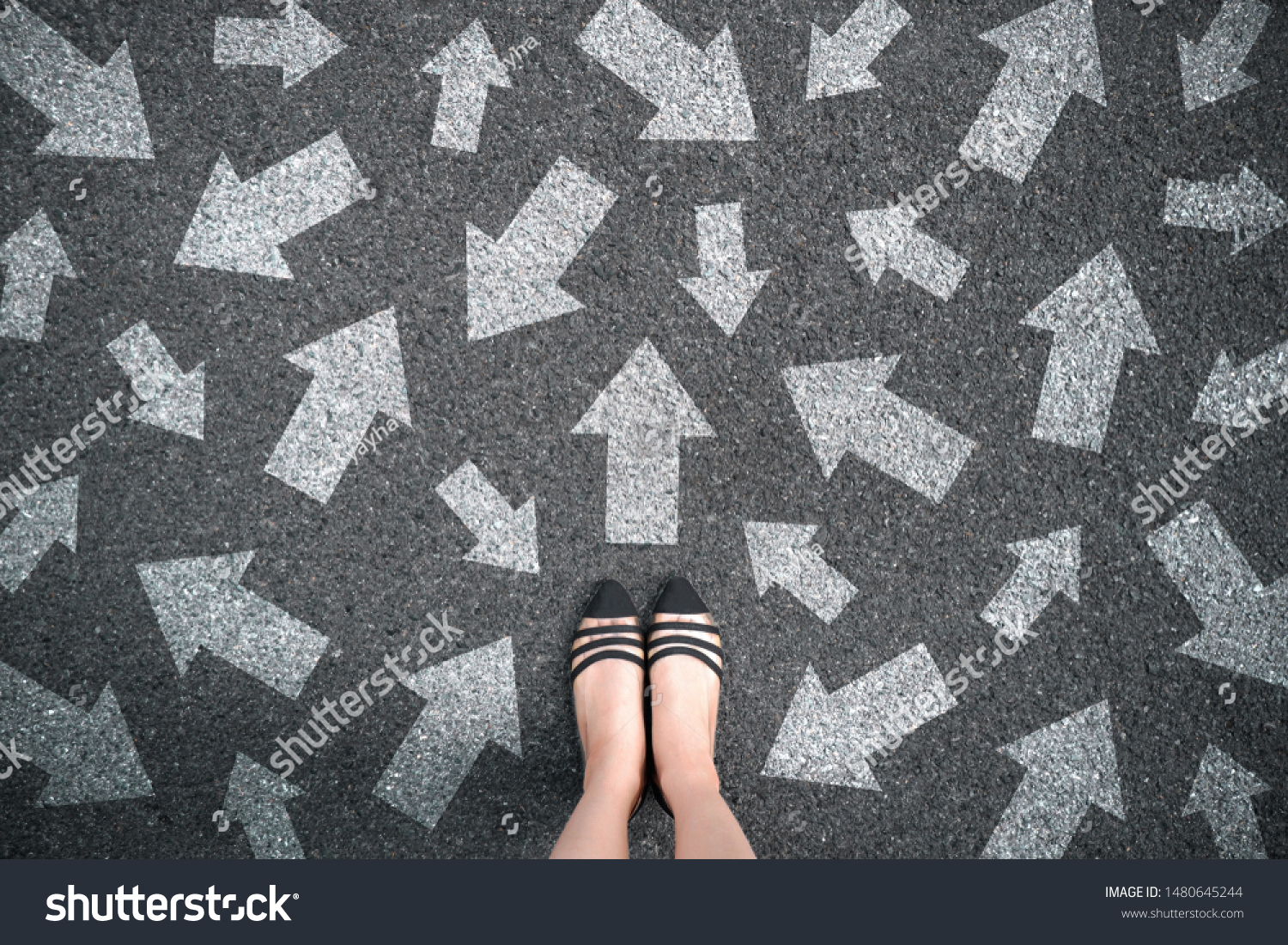 Feet and arrows on road background. Woman standing with many direction sign arrow choices in different ways, left and forward. Taking decisions for the future female. Top view of selfie foot and shoe. #1480645244